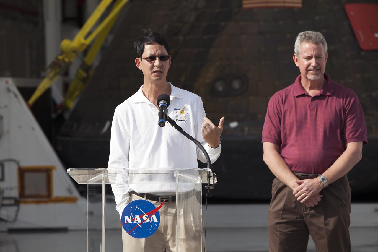 CAPE CANAVERAL, Fla. -- NASA's Orion spacecraft is viewed by members of the media at the Launch Abort System Facility at NASA's Kennedy Space Center in Florida. Speaking to the media during the viewing opportunity is Glenn Chin, Orion Production Operations. To his right is Phil Weber, with the Ground Systems Development and Operations Program, or GSDO. Orion made the 8-day, 2,700 mile overland trip back to Kennedy from Naval Base San Diego in California.  Analysis of date obtained during its two-orbit, four-and-a-half hour mission Dec. 5 will provide engineers with detailed information on how the spacecraft fared. GSDO led the recovery, offload and transportation efforts. For more information, visit www.nasa.gov/orion. Photo credit: NASA/Dimitri Gerondidakis