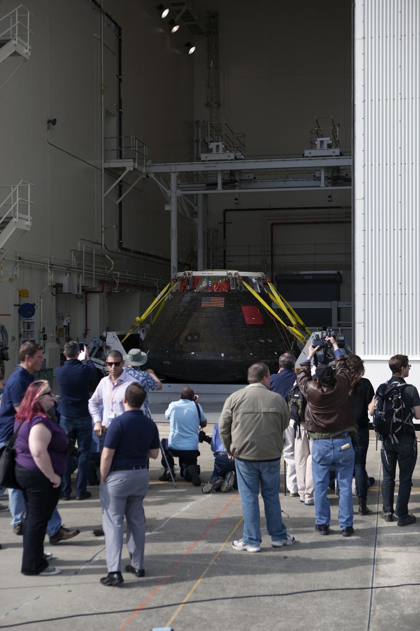 CAPE CANAVERAL, Fla. -- NASA's Orion spacecraft is viewed by members of the media at the Launch Abort System Facility at NASA's Kennedy Space Center in Florida. Orion made the 8-day, 2,700 mile overland trip back to Kennedy from Naval Base San Diego in California.  Analysis of date obtained during its two-orbit, four-and-a-half hour mission Dec. 5 will provide engineers detailed information on how the spacecraft fared. The Ground Systems Development and Operations Program led the recovery, offload and transportation efforts. For more information, visit www.nasa.gov/orion. Photo credit: NASA/Dimitri Gerondidakis