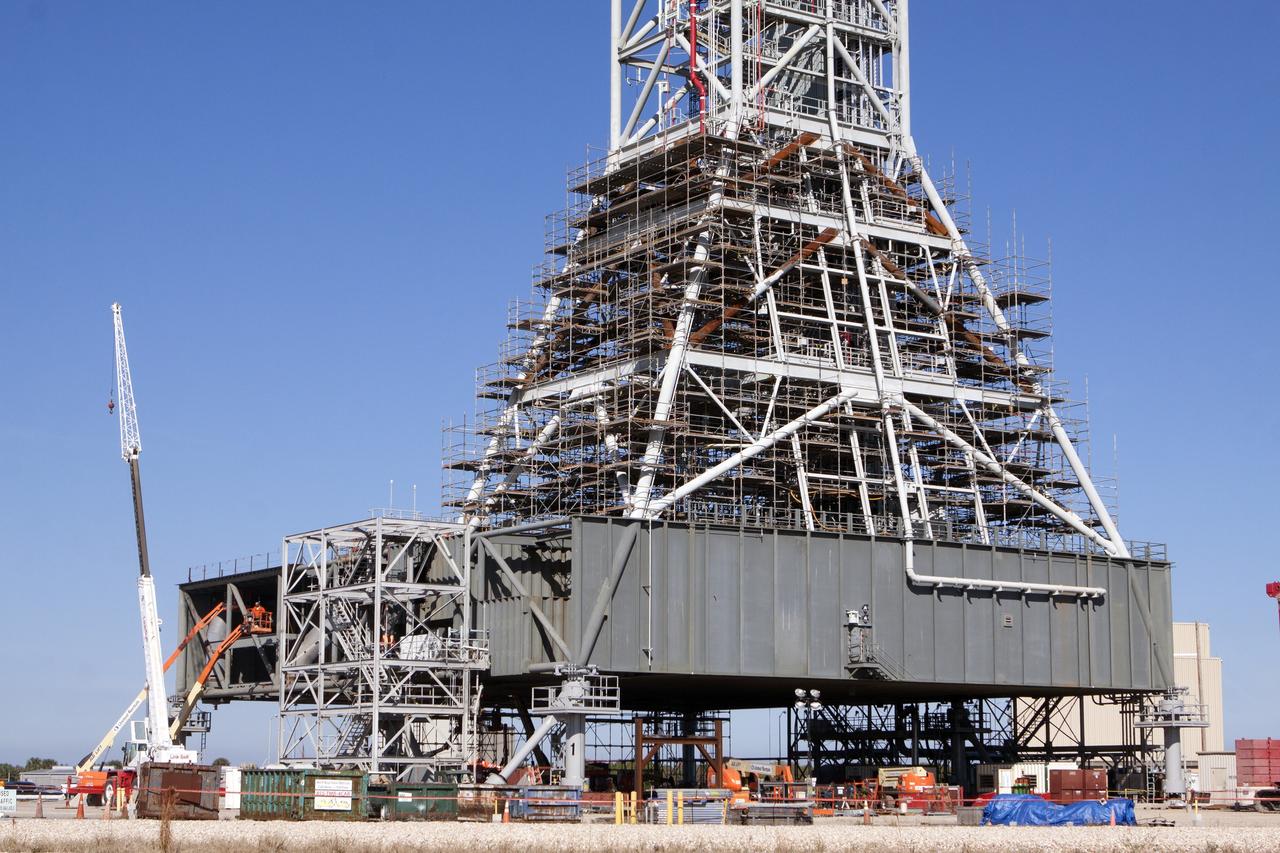 CAPE CANAVERAL, Fla. – Modifications continue on the Mobile Launcher, or ML, at the Mobile Launcher Park Site at NASA’s Kennedy Space Center in Florida. Scaffolding, or work platforms, have been installed around the base of the tower on the ML to continue upgrades and modifications to the structure. The ML is being modified and strengthened to accommodate the weight, size and thrust at launch of NASA's Space Launch System, or SLS, and Orion spacecraft. The ML is one of the key elements of ground support equipment that is being upgraded by the Ground Systems Development and Operations Program at Kennedy. The ML will carry the SLS rocket and Orion spacecraft to Launch Pad 39B for its first uncrewed mission, Exploration Mission-1, in 2018. Photo credit: NASA/Kim Shiflett