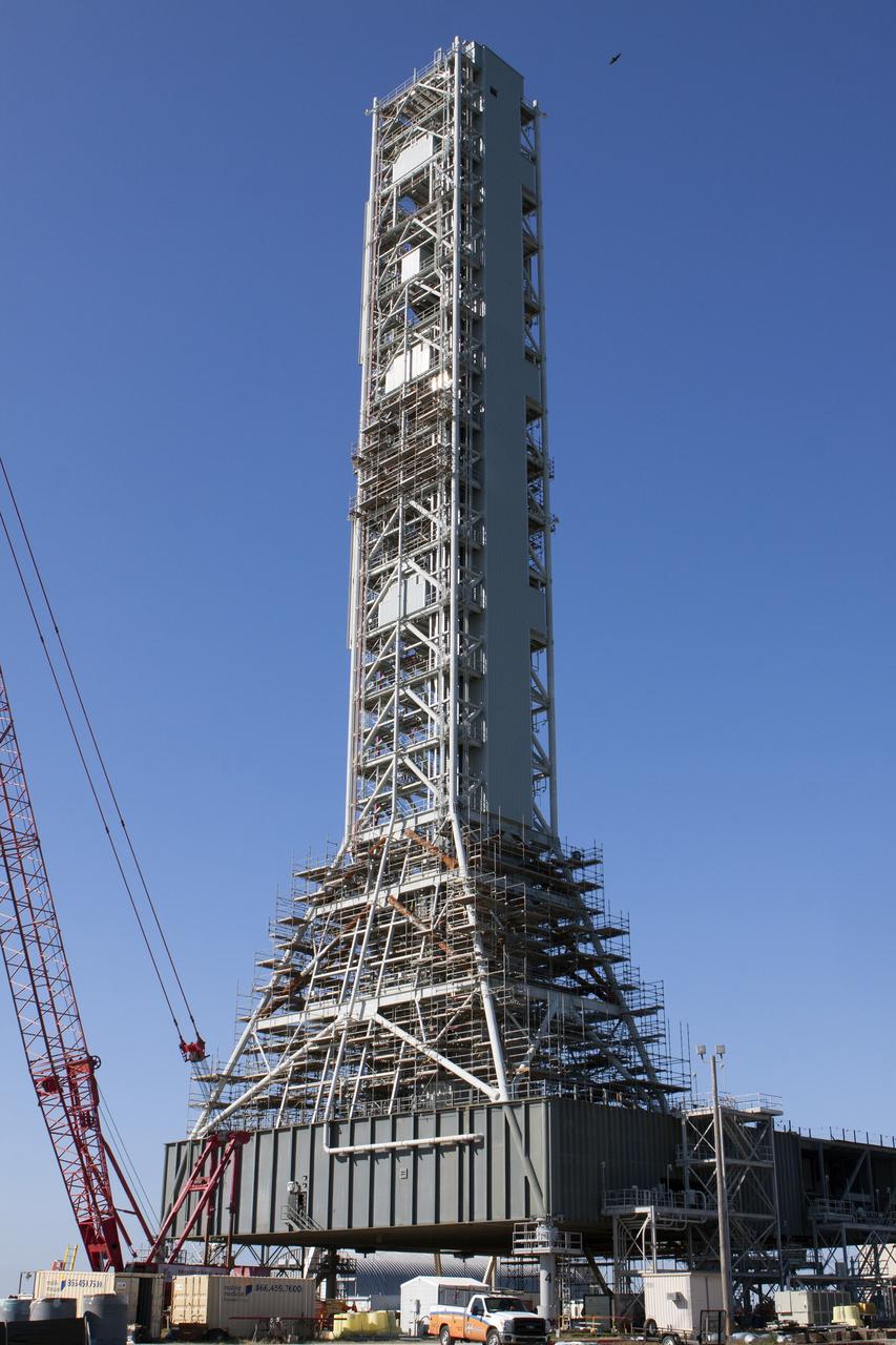 CAPE CANAVERAL, Fla. – Modifications continue on the Mobile Launcher, or ML, at the Mobile Launcher Park Site at NASA’s Kennedy Space Center in Florida. A crane is being used to move scaffolding, or work platforms, around the base of the tower on the ML to continue upgrades and modifications to the structure. The ML is being modified and strengthened to accommodate the weight, size and thrust at launch of NASA's Space Launch System, or SLS, and Orion spacecraft. The ML is one of the key elements of ground support equipment that is being upgraded by the Ground Systems Development and Operations Program at Kennedy. The ML will carry the SLS rocket and Orion spacecraft to Launch Pad 39B for its first uncrewed mission, Exploration Mission-1, in 2018. Photo credit: NASA/Kim Shiflett