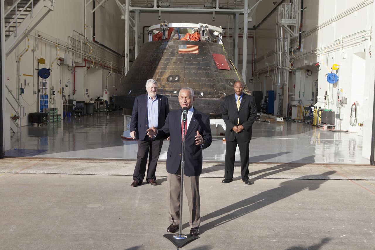 CAPE CANAVERAL, Fla. -- NASA Administrator Charlie Bolden looked over the agency's Orion spacecraft this morning for the first time since it returned to Kennedy Space Center following the successful Orion flight test on Dec. 5. At right is Kennedy Space Center Associate Director Kelvin Manning. At left is Paul Cooper, a Lockheed Martin manager. Bearing the marks of a spacecraft that has returned to Earth through a searing plunge into the atmosphere, Orion is perched on a pedestal inside the Launch Abort System Facility at Kennedy where it is going through post-mission processing. Although the spacecraft Bolden looked over did not fly with a crew aboard during the flight test, Orion is designed to carry astronauts into deep space in the future setting NASA and the nation firmly on the journey to Mars. Photo credit: NASA/Cory Huston
