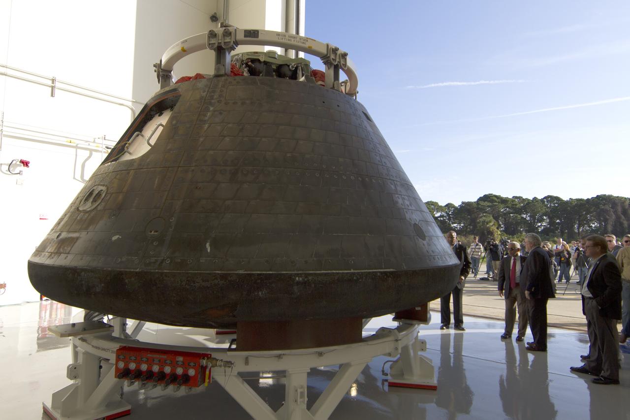 CAPE CANAVERAL, Fla. -- NASA Administrator Charlie Bolden, third from right, looked over the agency's Orion spacecraft this morning for the first time since it returned to Kennedy Space Center following the successful Orion flight test on Dec. 5. At far right is Jules Schneider, Lockheed Martin manager. Standing near Bolden is Paul Cooper, a Lockheed Martin manager. At far left is Kennedy Space Center Associate Director Kelvin Manning. Bearing the marks of a spacecraft that has returned to Earth through a searing plunge into the atmosphere, Orion is perched on a pedestal inside the Launch Abort System Facility at Kennedy where it is going through post-mission processing. Although the spacecraft Bolden looked over did not fly with a crew aboard during the flight test, Orion is designed to carry astronauts into deep space in the future setting NASA and the nation firmly on the journey to Mars. Photo credit: NASA/Cory Huston
