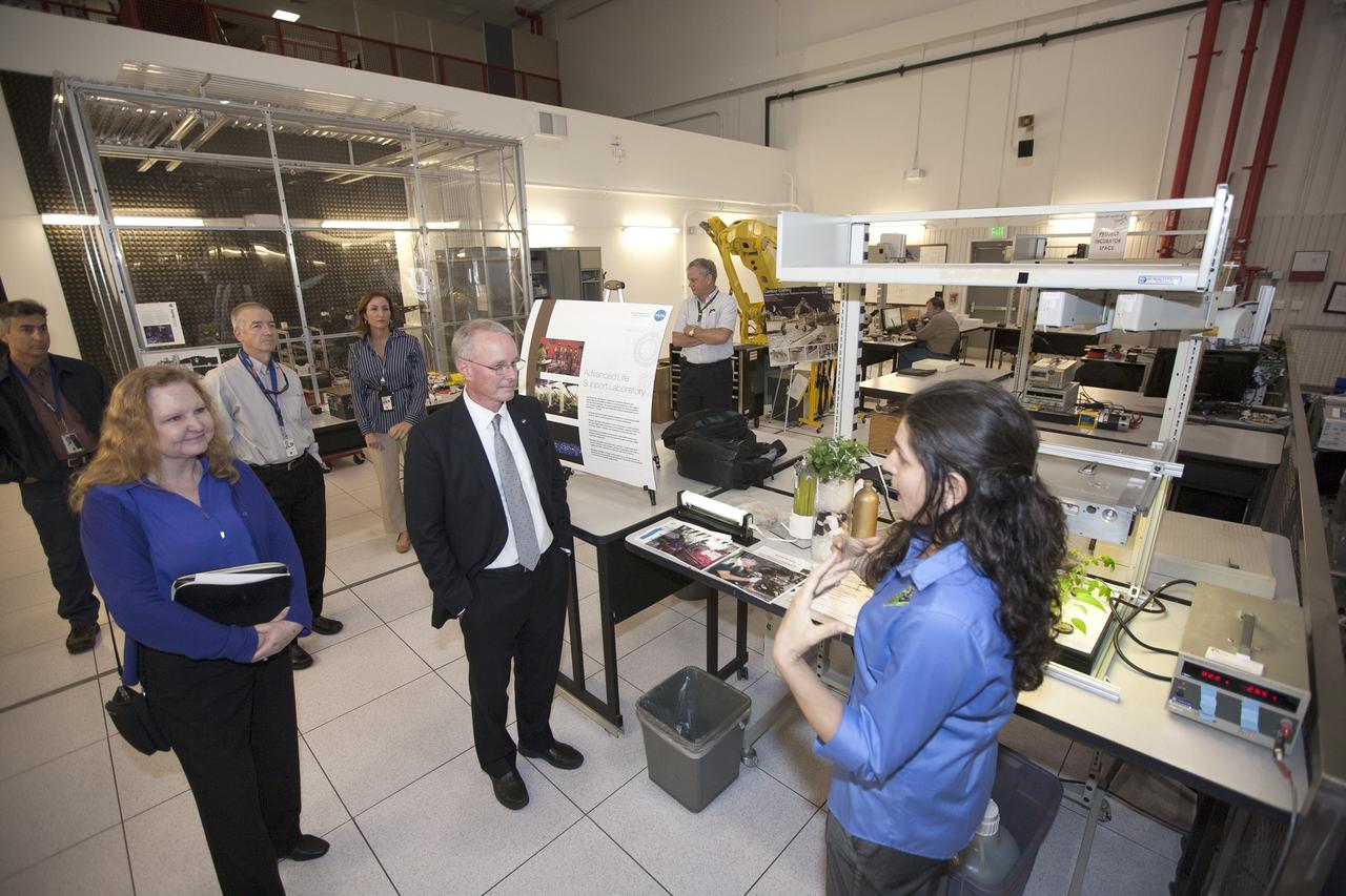 CAPE CANAVERAL, Fla. -- During a visit to NASA's Kennedy Space Center in Florida, NASA Chief Technologist David Miller, center, tours laboratories inside the Swamp Works facility. At right, Dr. Gioia Massa, NASA project scientist in the Engineering and Technology Directorate, discusses the VEGGIE plant growth system. At left is Karen Thompson, Kennedy's chief technologist. Photo credit: NASA/Kim Shiflett
