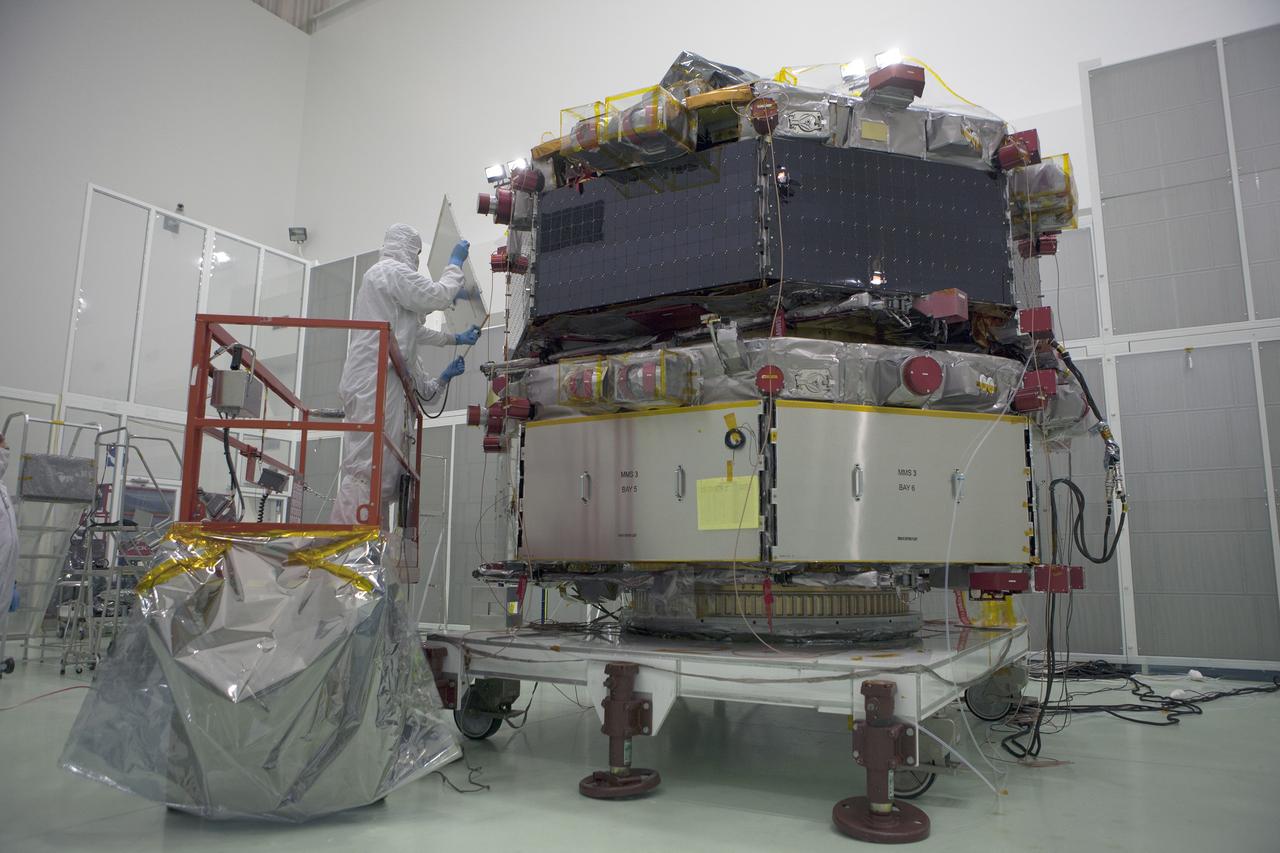The protective covers are removed from around the solar panels on the upper stack of the Magnetospheric Multiscale spacecraft, or MMS, in the Astrotech payload processing facility in Titusville, Florida, near Kennedy Space Center. Preparations are underway for illumination testing of the spacecraft's upper stack. Illumination testing of the lower instrumentation payload stack was completed in December. Launch aboard a United Launch Alliance Atlas V rocket from Space Launch Complex 41 on Cape Canaveral Air Force Station is targeted for March 12. To learn more about MMS, visit http://www.nasa.gov/mms.  Photo credit: NASA/Kim Shiflett