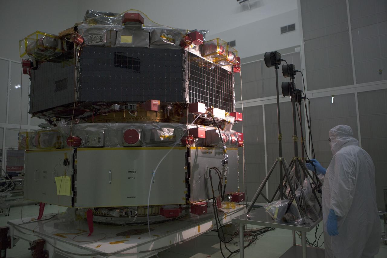 CAPE CANAVERAL, Fla. – A solar array illumination test is performed on the upper stack of the Magnetospheric Multiscale spacecraft, or MMS, in the Astrotech payload processing facility in Titusville, Florida, near Kennedy Space Center. Illumination testing of the lower instrumentation payload stack was completed in December.    MMS is a Solar Terrestrial Probes mission comprising four identically instrumented spacecraft that will use Earth’s magnetosphere as a laboratory to study the microphysics of three fundamental plasma processes: magnetic reconnection, energetic particle acceleration and turbulence.  Launch aboard a United Launch Alliance Atlas V rocket from Space Launch Complex 41 on Cape Canaveral Air Force Station is targeted for March 12, 2015. To learn more about MMS, visit http://www.nasa.gov/mms.  Photo credit: NASA/Kim Shiflett