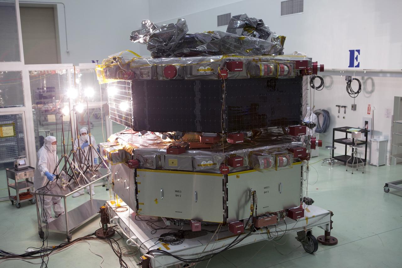 CAPE CANAVERAL, Fla. – A solar array illumination test is performed on the upper stack of the Magnetospheric Multiscale spacecraft, or MMS, in the Astrotech payload processing facility in Titusville, Florida, near Kennedy Space Center. Illumination testing of the lower instrumentation payload stack was completed in December.    MMS is a Solar Terrestrial Probes mission comprising four identically instrumented spacecraft that will use Earth’s magnetosphere as a laboratory to study the microphysics of three fundamental plasma processes: magnetic reconnection, energetic particle acceleration and turbulence.  Launch aboard a United Launch Alliance Atlas V rocket from Space Launch Complex 41 on Cape Canaveral Air Force Station is targeted for March 12, 2015. To learn more about MMS, visit http://www.nasa.gov/mms.  Photo credit: NASA/Kim Shiflett