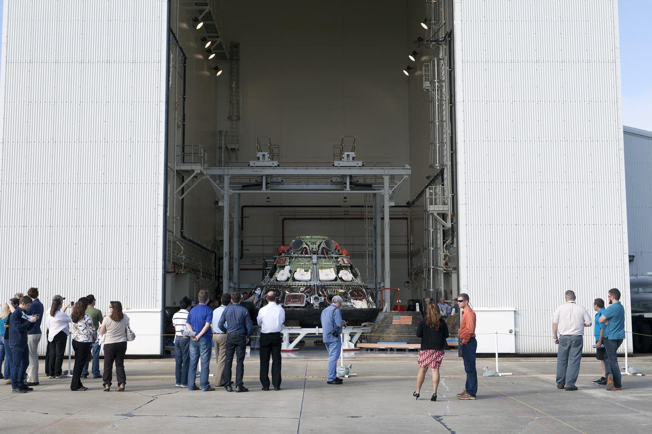 CAPE CANAVERAL, Fla. -- Workers take photographs of NASA's Orion spacecraft during a viewing at the Launch Abort System Facility at NASA's Kennedy Space Center in Florida. Orion's back shell panels have been removed. The spacecraft completed the first flight test in December, was retrieved from the Pacific Ocean, and transported 2,700 miles overland to Kennedy from Naval Base San Diego in California. Analysis of data obtained during its two-orbit, four-and-a-half hour mission Dec. 5 will provide engineers detailed information on how the spacecraft fared. Orion will be transported to the Payload Hazardous Servicing Facility for deservicing. For more information, visit www.nasa.gov/orion. Photo credit: NASA/Kim Shiflett
