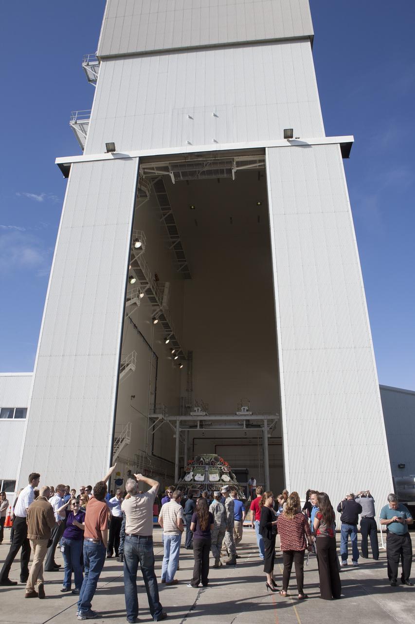 CAPE CANAVERAL, Fla. -- Workers take photographs of NASA's Orion spacecraft during a viewing at the Launch Abort System Facility at NASA's Kennedy Space Center in Florida. Orion's back shell panels have been removed. The spacecraft completed the first flight test in December, was retrieved from the Pacific Ocean, and transported 2,700 miles overland to Kennedy from Naval Base San Diego in California. Analysis of data obtained during its two-orbit, four-and-a-half hour mission Dec. 5 will provide engineers detailed information on how the spacecraft fared. Orion will be transported to the Payload Hazardous Servicing Facility for deservicing. For more information, visit www.nasa.gov/orion. Photo credit: NASA/Kim Shiflett