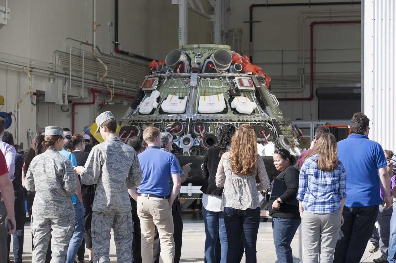 CAPE CANAVERAL, Fla. -- Workers take photographs of NASA's Orion spacecraft during a viewing at the Launch Abort System Facility at NASA's Kennedy Space Center in Florida. Orion's back shell panels have been removed. The spacecraft completed the first flight test in December, was retrieved from the Pacific Ocean, and transported 2,700 miles overland to Kennedy from Naval Base San Diego in California. Analysis of data obtained during its two-orbit, four-and-a-half hour mission Dec. 5 will provide engineers detailed information on how the spacecraft fared. Orion will be transported to the Payload Hazardous Servicing Facility for deservicing. For more information, visit www.nasa.gov/orion. Photo credit: NASA/Kim Shiflett