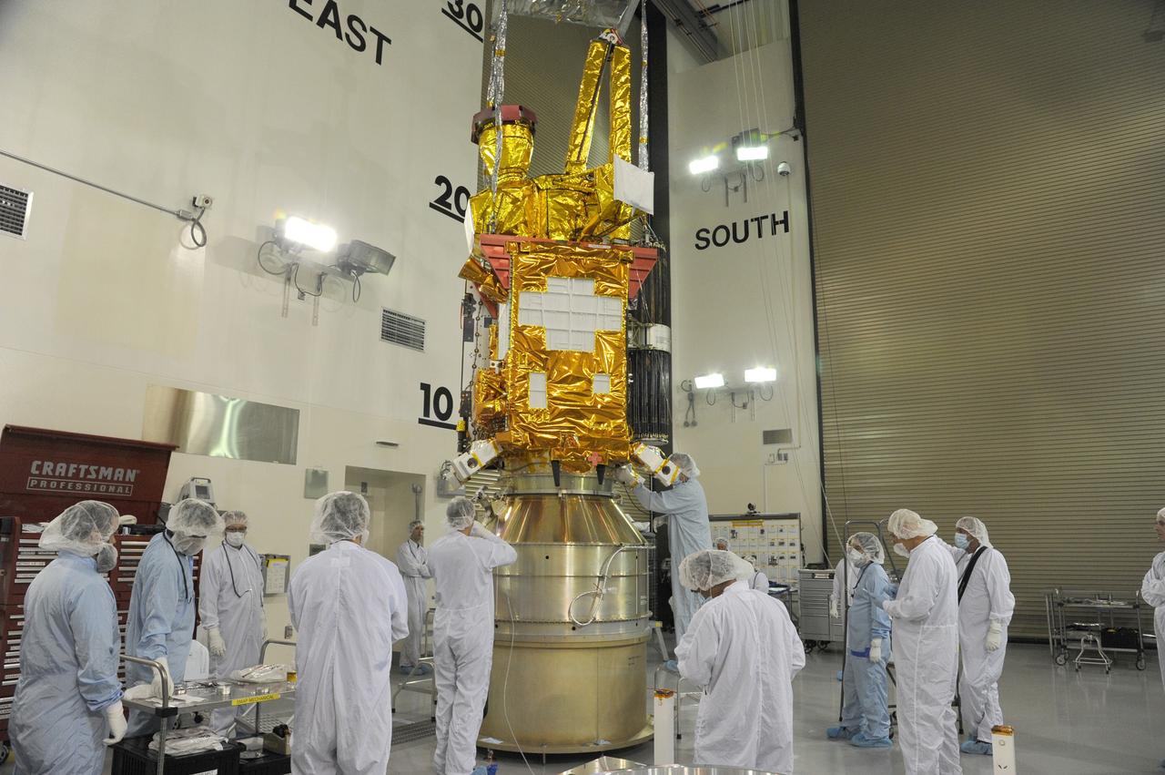 VANDENBERG AIR FORCE BASE, Calif. – Technicians connect NASA's Soil Moisture Active Passive, or SMAP, spacecraft to the Delta II payload attach structure in the Astrotech payload processing facility on Vandenberg Air Force Base in California. The structure will secure the spacecraft to the rocket's second stage.    SMAP will launch on a Delta II 7320 configuration vehicle featuring a United Launch Alliance first stage booster powered by an Aerojet Rocketdyne RS-27A main engine and three Alliant Techsystems, or ATK, strap-on solid rocket motors. Once on station in Earth orbit, SMAP will provide global measurements of soil moisture and its freeze/thaw state. These measurements will be used to enhance understanding of processes that link the water, energy and carbon cycles, and to extend the capabilities of weather and climate prediction models. SMAP data also will be used to quantify net carbon flux in boreal landscapes and to develop improved flood prediction and drought monitoring capabilities. Launch from Space Launch Complex 2 is targeted for Jan. 29, 2015. To learn more about SMAP, visit http://www.nasa.gov/smap.  Photo credit: NASA/Chris Wiant, U.S. Air Force Photo Squadron