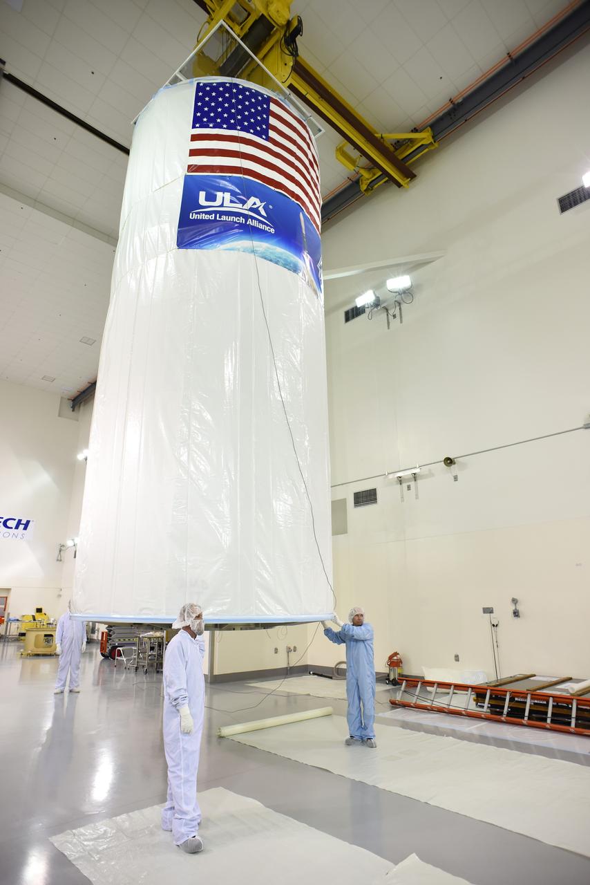 VANDENBERG AIR FORCE BASE, Calif. – In the Astrotech payload processing facility on Vandenberg Air Force Base in California, NASA's Soil Moisture Active Passive, or SMAP, spacecraft has had the appropriate logos affixed to its transportation canister before its move to the launch pad.    SMAP will launch on a United Launch Alliance Delta II 7320 configuration vehicle featuring a United Launch Alliance first stage booster powered by an Aerojet Rocketdyne RS-27A main engine and three Alliant Techsystems, or ATK, strap-on solid rocket motors. Once on station in Earth orbit, SMAP will provide global measurements of soil moisture and its freeze/thaw state. These measurements will be used to enhance understanding of processes that link the water, energy and carbon cycles, and to extend the capabilities of weather and climate prediction models. SMAP data also will be used to quantify net carbon flux in boreal landscapes and to develop improved flood prediction and drought monitoring capabilities. Launch from Space Launch Complex 2 is targeted for Jan. 29. To learn more about SMAP, visit http://www.nasa.gov/smap.  Photo credit: NASA/U.S. Air Force Photo Squadron