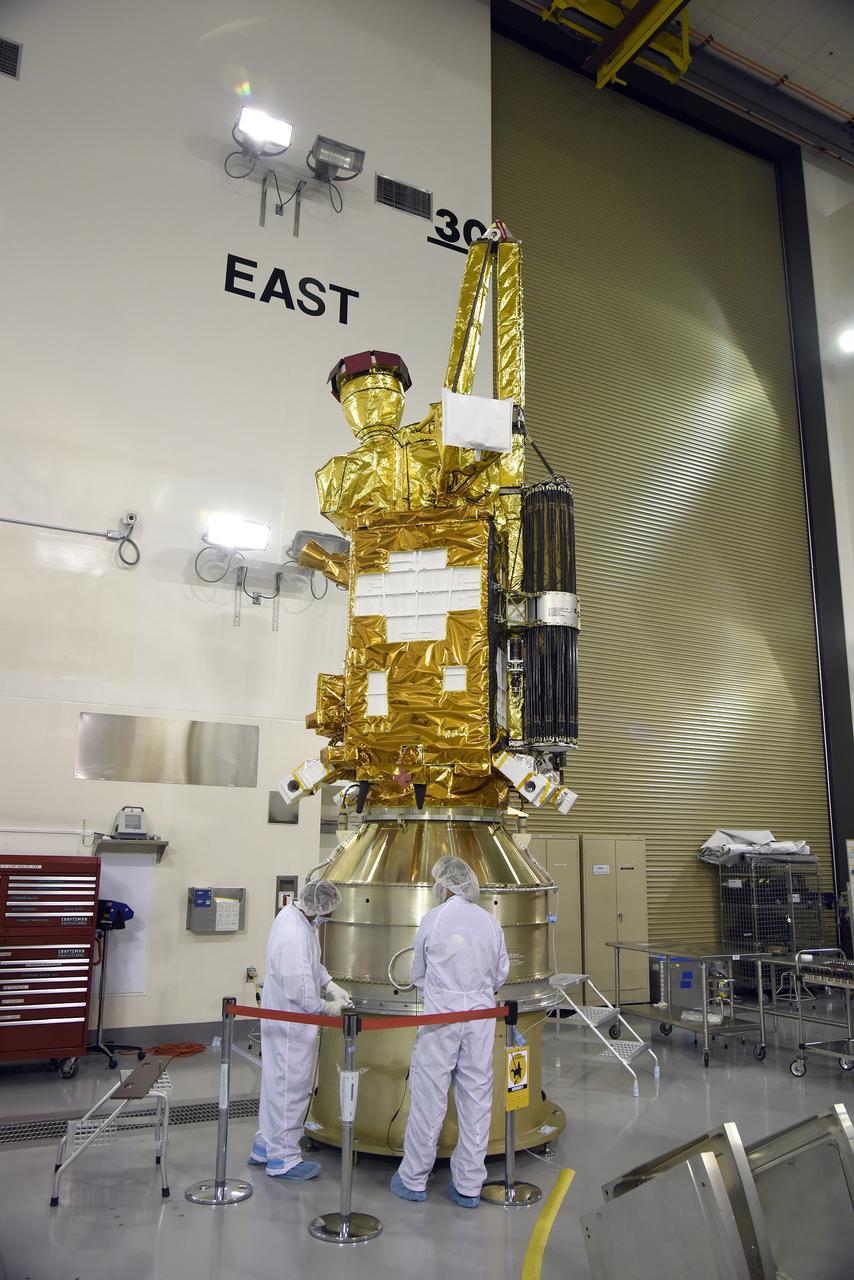 VANDENBERG AIR FORCE BASE, Calif. – Inside the Astrotech payload processing facility at Vandenberg Air Force Base in California, engineers and technicians inspect NASA's Soil Moisture Active Passive mission, or SMAP, satellite. SMAP will provide global measurements of soil moisture and its freeze/thaw state. These measurements will be used to enhance understanding of processes that link the water, energy and carbon cycles, and to extend the capabilities of weather and climate prediction models. SMAP data also will be used to quantify net carbon flux in boreal landscapes and to develop improved flood prediction and drought monitoring capabilities. Launch is scheduled for Jan. 29, 2015. To learn more about SMAP, visit http://smap.jpl.nasa.gov Photo credit: Jeremy Moore, USAF Photo Squadron