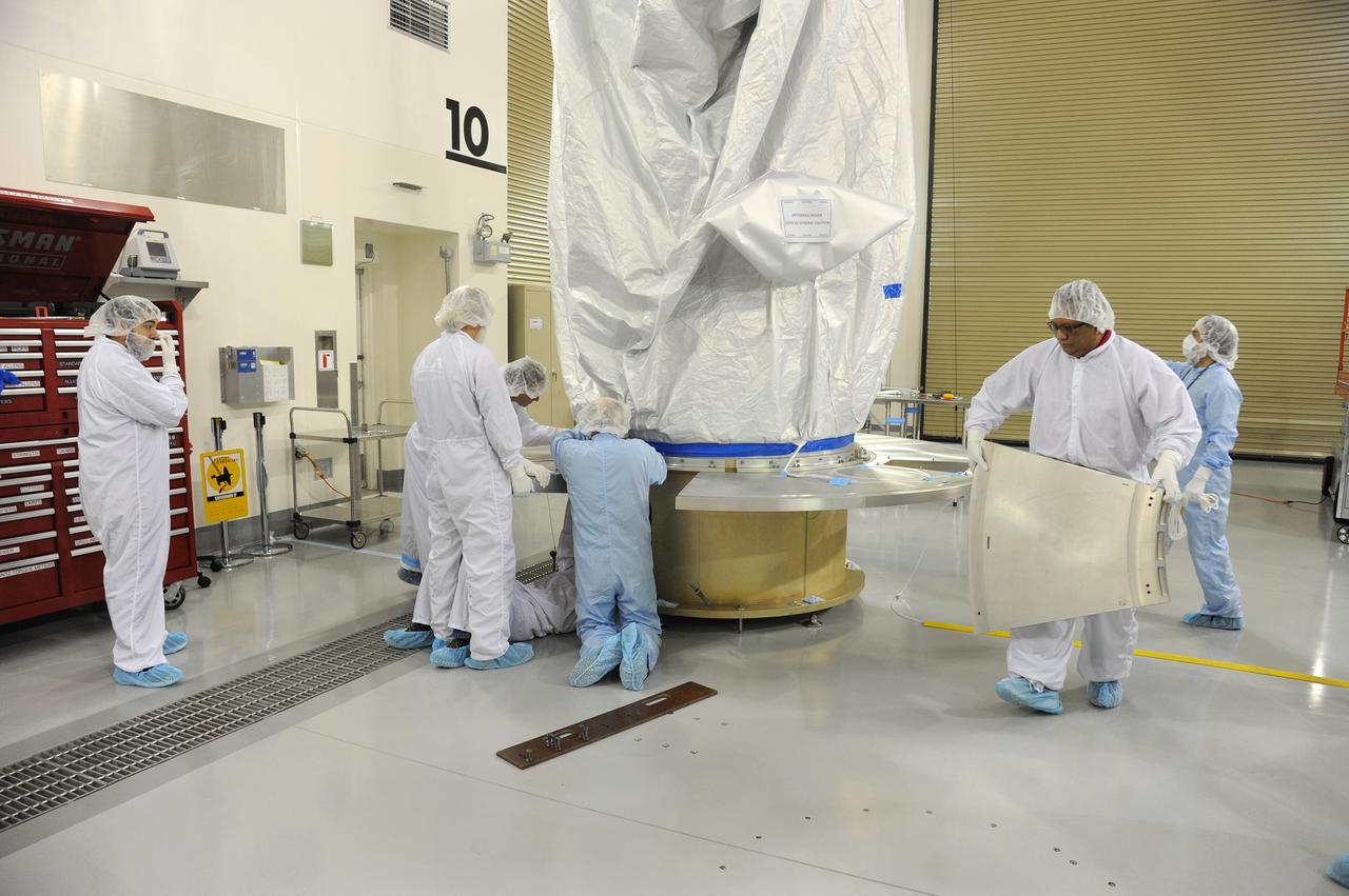 VANDENBERG AFB, California – Technicians and engineers place a transportation canister around NASA's SMAP spacecraft so it can be taken from the Astrotech processing facility to Space Launch Complex-2 for placement atop a Delta II rocket for launch. For more, go to www.nasa.gov/smap Photo credit: USAF/John Davila