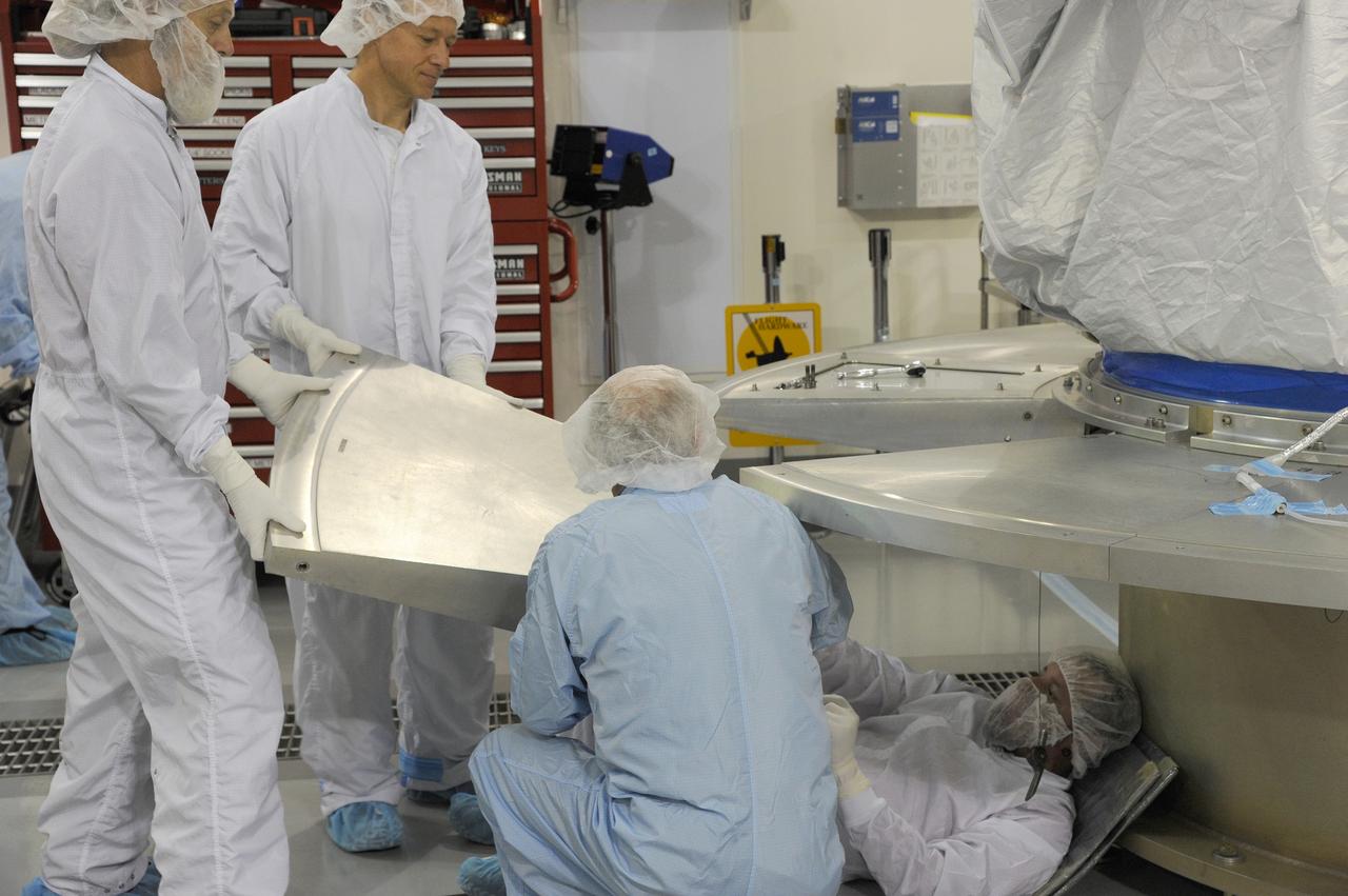 VANDENBERG AFB, California – Technicians and engineers place a transportation canister around NASA's SMAP spacecraft so it can be taken from the Astrotech processing facility to Space Launch Complex-2 for placement atop a Delta II rocket for launch. For more, go to www.nasa.gov/smap Photo credit: USAF/John Davila
