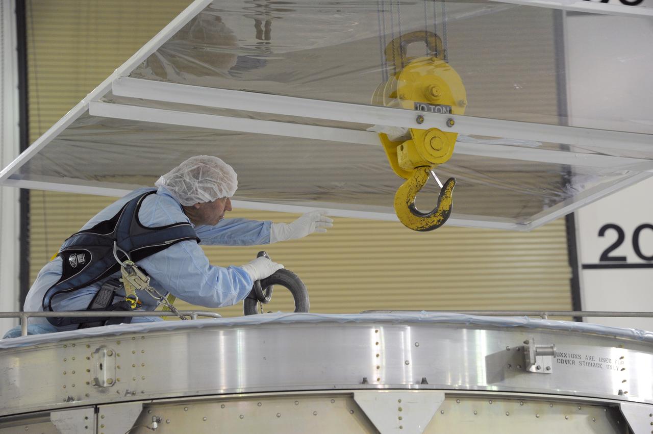 VANDENBERG AFB, California – Technicians and engineers place a transportation canister around NASA's SMAP spacecraft so it can be taken from the Astrotech processing facility to Space Launch Complex-2 for placement atop a Delta II rocket for launch. For more, go to www.nasa.gov/smap Photo credit: USAF/John Davila
