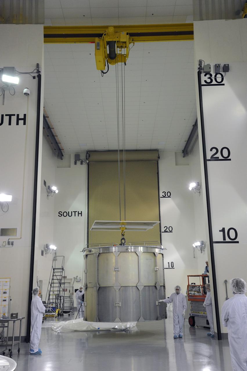 VANDENBERG AFB, California – Technicians and engineers place a transportation canister around NASA's SMAP spacecraft so it can be taken from the Astrotech processing facility to Space Launch Complex-2 for placement atop a Delta II rocket for launch. For more, go to www.nasa.gov/smap Photo credit: USAF/John Davila