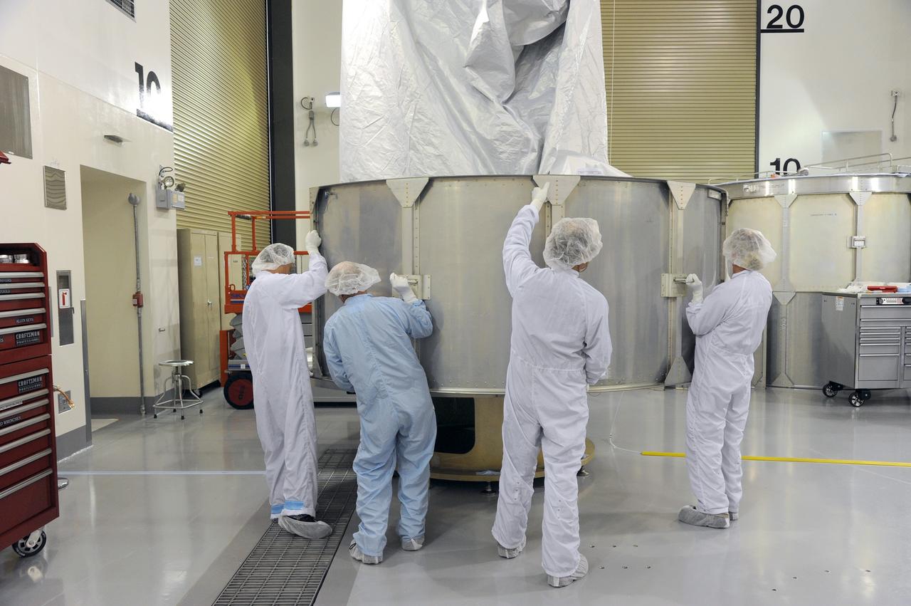 VANDENBERG AFB, California – Technicians and engineers place a transportation canister around NASA's SMAP spacecraft so it can be taken from the Astrotech processing facility to Space Launch Complex-2 for placement atop a Delta II rocket for launch. For more, go to www.nasa.gov/smap Photo credit: USAF/John Davila