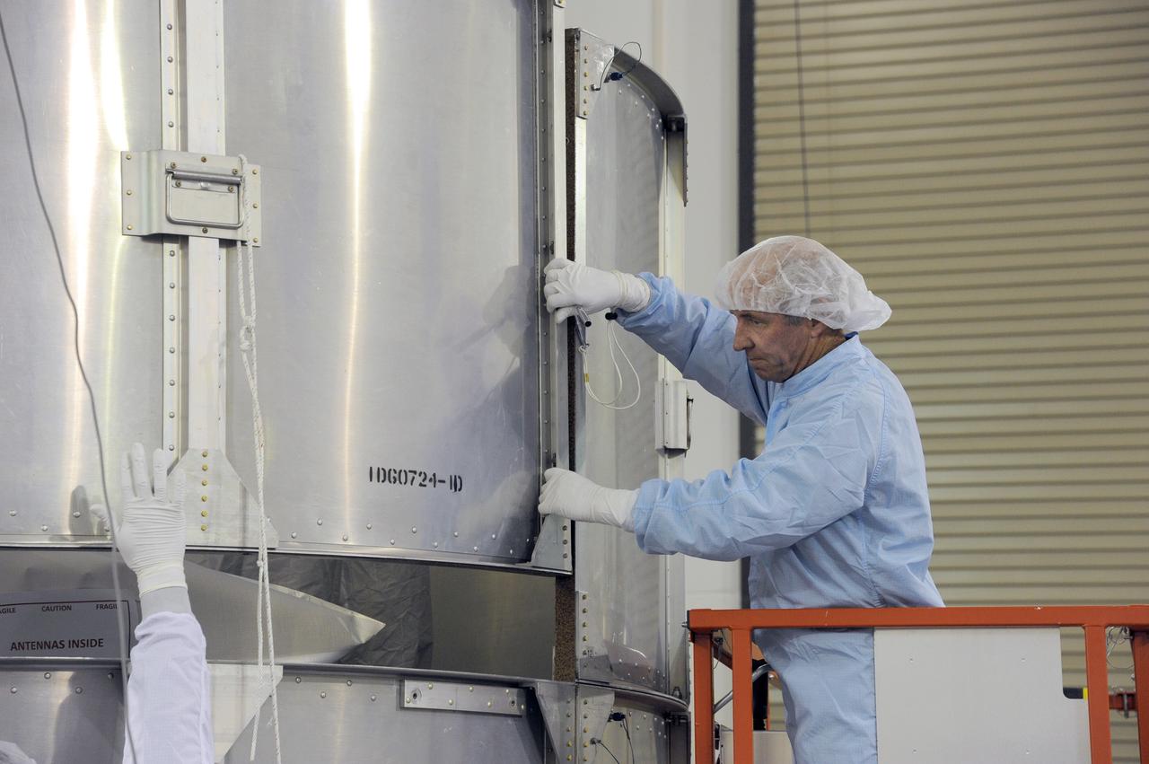 VANDENBERG AFB, California – Technicians and engineers place a transportation canister around NASA's SMAP spacecraft so it can be taken from the Astrotech processing facility to Space Launch Complex-2 for placement atop a Delta II rocket for launch. For more, go to www.nasa.gov/smap Photo credit: USAF/John Davila