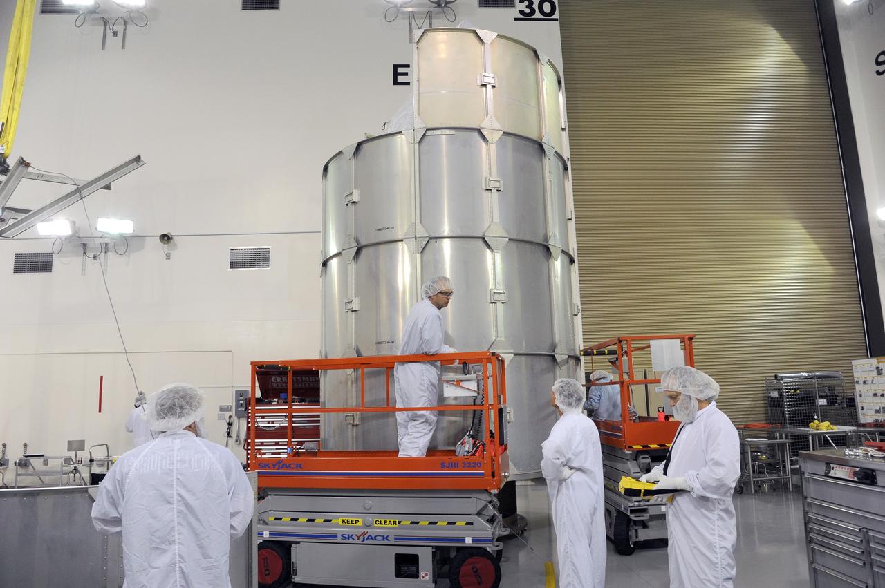 VANDENBERG AFB, California – Technicians and engineers place a transportation canister around NASA's SMAP spacecraft so it can be taken from the Astrotech processing facility to Space Launch Complex-2 for placement atop a Delta II rocket for launch. For more, go to www.nasa.gov/smap Photo credit: USAF/John Davila