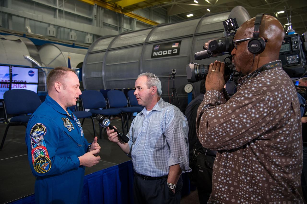 HOUSTON, Texas - jsc2015e031284- NASA astronaut Mike Fincke discusses the agency's Commercial Crew Program with a television news crew following a presentation about the agency's Commercial Crew Program. Photo credit: NASA/Robert Markowitz