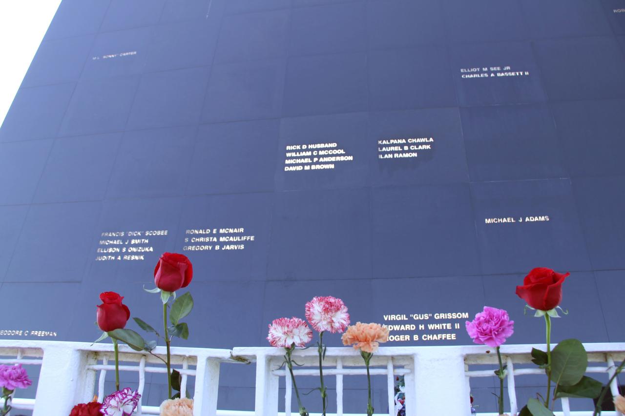 CAPE CANAVERAL, Fla. – NASA’s Kennedy Space Center in Florida paid tribute to the crews of Apollo 1 and space shuttles Challenger and Columbia, as well as other NASA astronauts who lost their lives while furthering the cause of exploration and discovery, during the agency's Day of Remembrance, Jan. 28.  Kennedy workers and guests attached roses and carnations to the fence during a wreath-laying ceremony at the Space Mirror Memorial located in the Kennedy Space Center Visitor Complex. Photo credit: NASA/Jim Grossmann