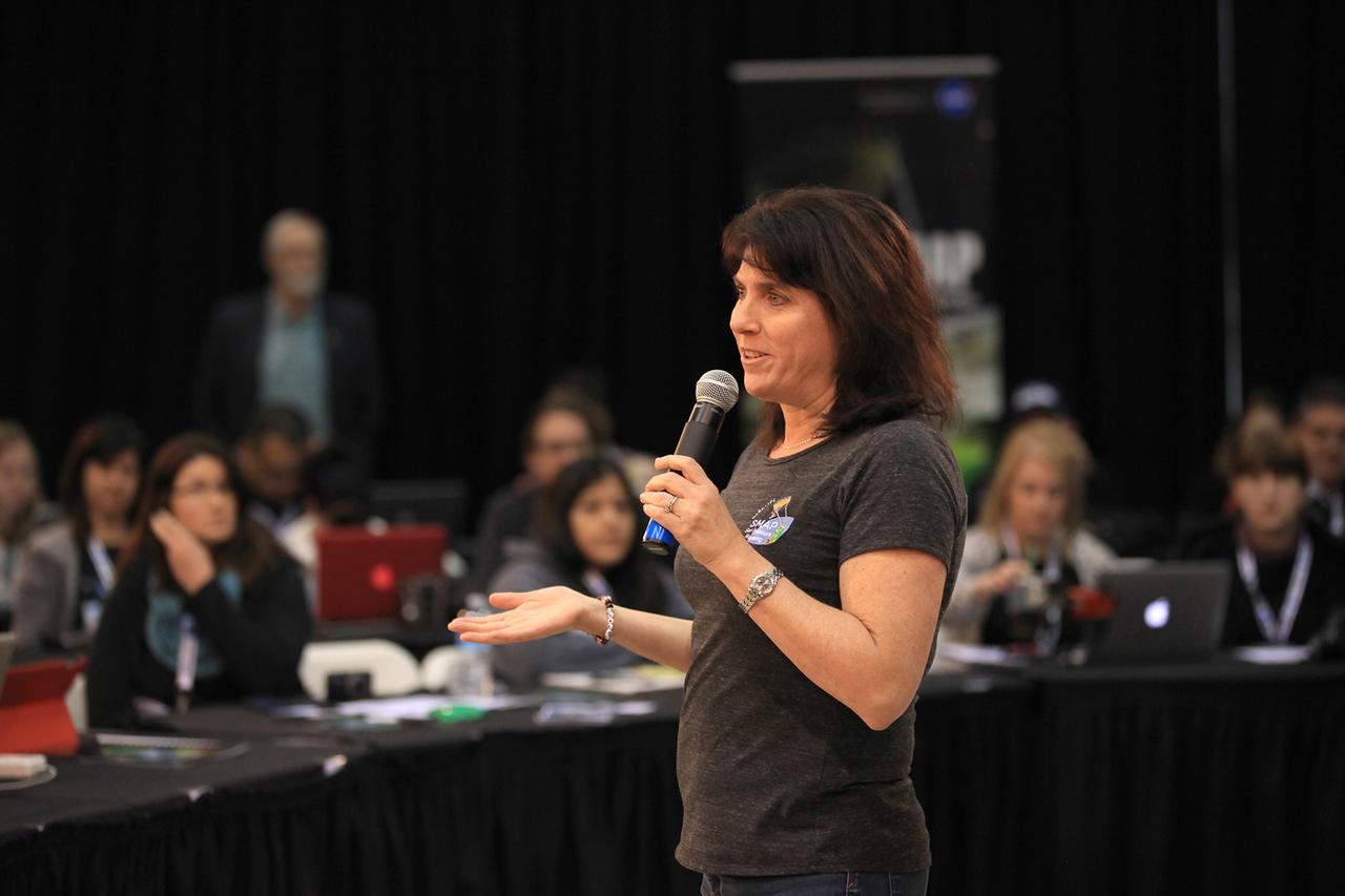 VANDENBERG AIR FORCE BASE, Calif. – Wendy Edelstein, instrument manager for NASA's Soil Moisture Active Passive mission, or SMAP, discusses the science and engineering of the mission with the audience of a NASA Social held at Vandenberg Air Force Base in California. This NASA Social brought together mission scientists and engineers with an audience of 70 students, educators, social media managers, bloggers, photographers and videographers who were selected from a pool of 325 applicants from 45 countries to participate in launch activities and communicate their experience with social media followers. The SMAP mission is scheduled to launch from Vandenberg on Jan. 29. To learn more about SMAP, visit http://www.nasa.gov/smap.  Photo credit: NASA/Kim Shiflett