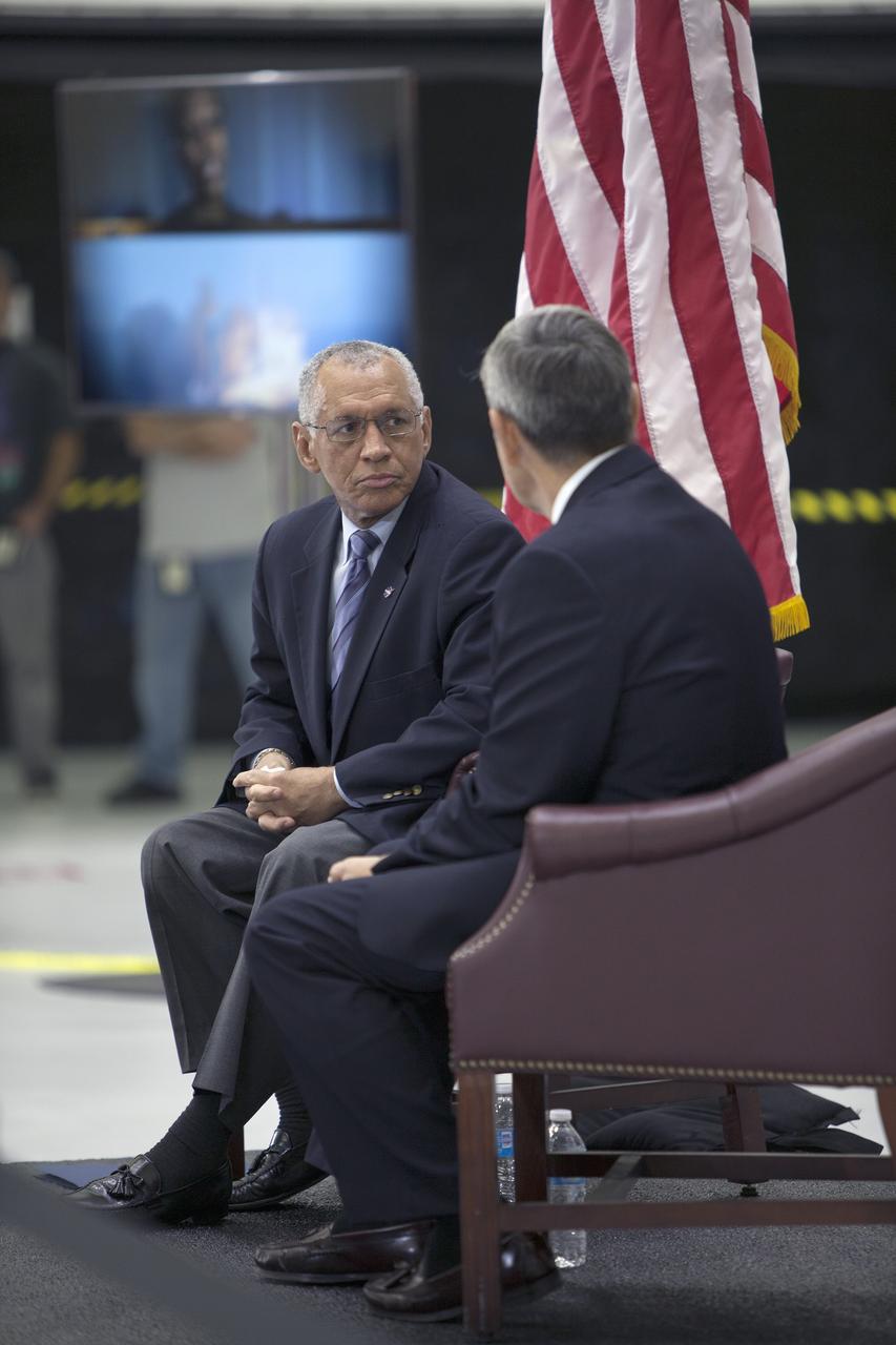 CAPE CANAVERAL, Fla. – In the Neil Armstrong Operations and Checkout Building high bay at NASA's Kennedy Space Center in Florida, NASA Administrator Charlie Bolden, at left, takes a few moments to consult with Kennedy Space Center Director Bob Cabana before delivering a "state of the agency" address at NASA's televised fiscal year 2016 budget rollout event. Representatives from the Kennedy workforce, news media and social media were in attendance. NASA's Orion, SpaceX Dragon and Boeing CST-100 spacecraft, all destined to play a role in NASA’s overall exploration objectives, were on display.  For information on NASA's budget, visit http://www.nasa.gov/budget. Photo credit: NASA/Gianni Woods