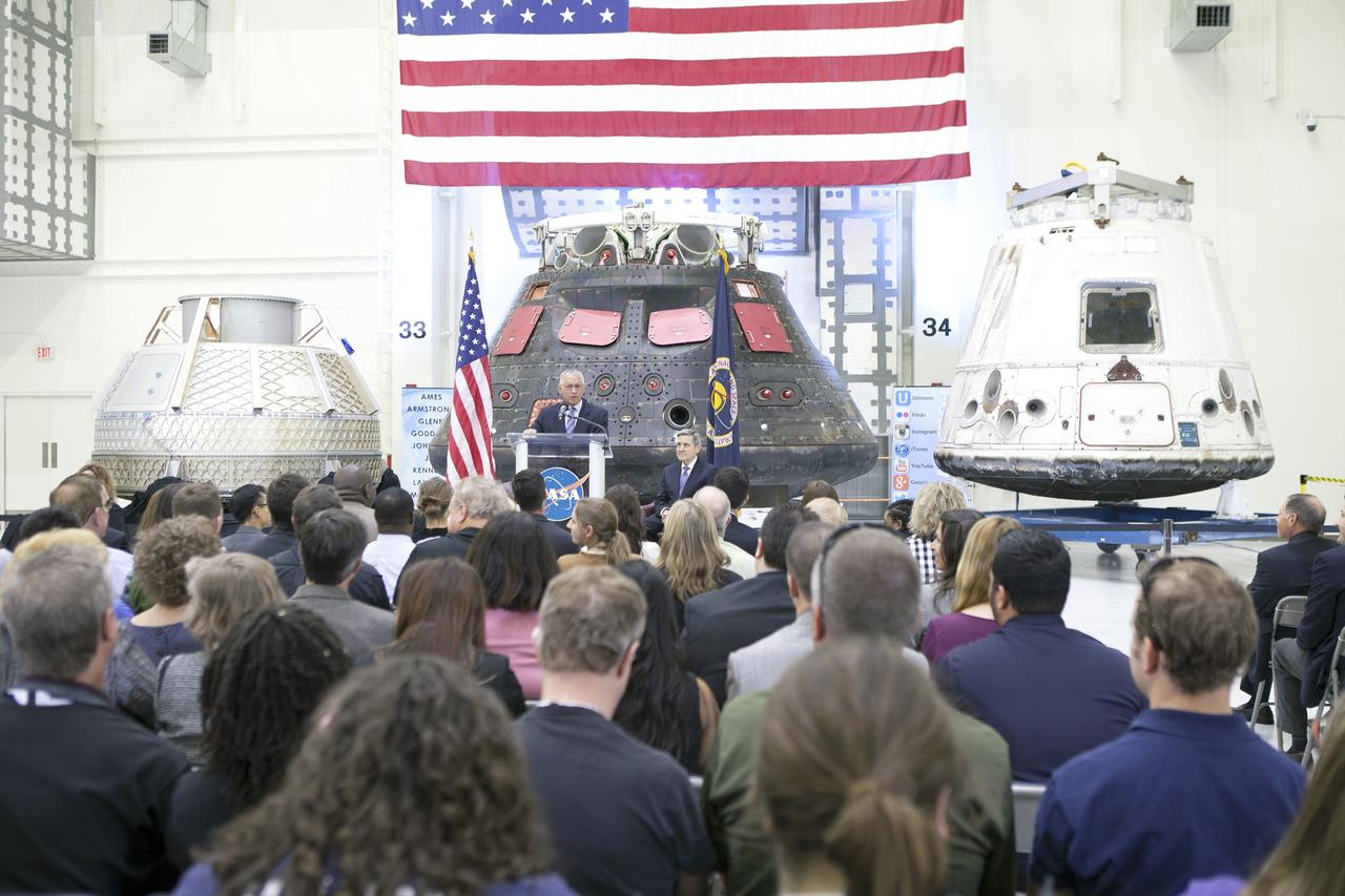 CAPE CANAVERAL, Fla. – In the Neil Armstrong Operations and Checkout Building high bay at NASA's Kennedy Space Center in Florida, NASA Administrator Charlie Bolden delivers a “state of the agency” address at NASA's televised fiscal year 2016 budget rollout event. Kennedy Space Center Director Bob Cabana, seated, made the opening remarks. Representatives from the Kennedy workforce, news media and social media were in attendance. NASA's Orion, SpaceX Dragon and Boeing CST-100 spacecraft, all destined to play a role in NASA’s overall exploration objectives, were on display. For information on NASA's budget, visit http://www.nasa.gov/budget. Photo credit: NASA/Gianni Woods