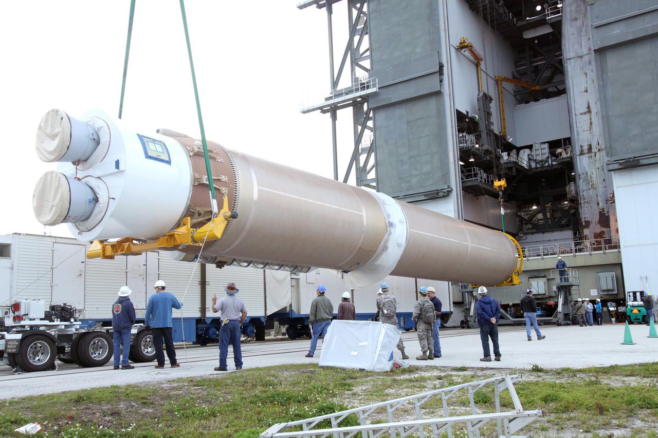 CAPE CANAVERAL, Fla. – The first stage of the United Launch Alliance Atlas V rocket for NASA's Magnetospheric Multiscale mission, or MMS, is lifted into the mobile service tower at Space Launch Complex 41 on Cape Canaveral Air Force Station in Florida. MMS will study the mystery of how magnetic fields around Earth connect and disconnect, explosively releasing energy via a process known a magnetic reconnection. MMS consists of four identical spacecraft that work together to provide the first three-dimensional view of this fundamental process, which occurs throughout the universe.  Launch is set for March 12. To learn more about MMS, visit http://www.nasa.gov/mms.  Photo credit: NASA/Jim Grossmann