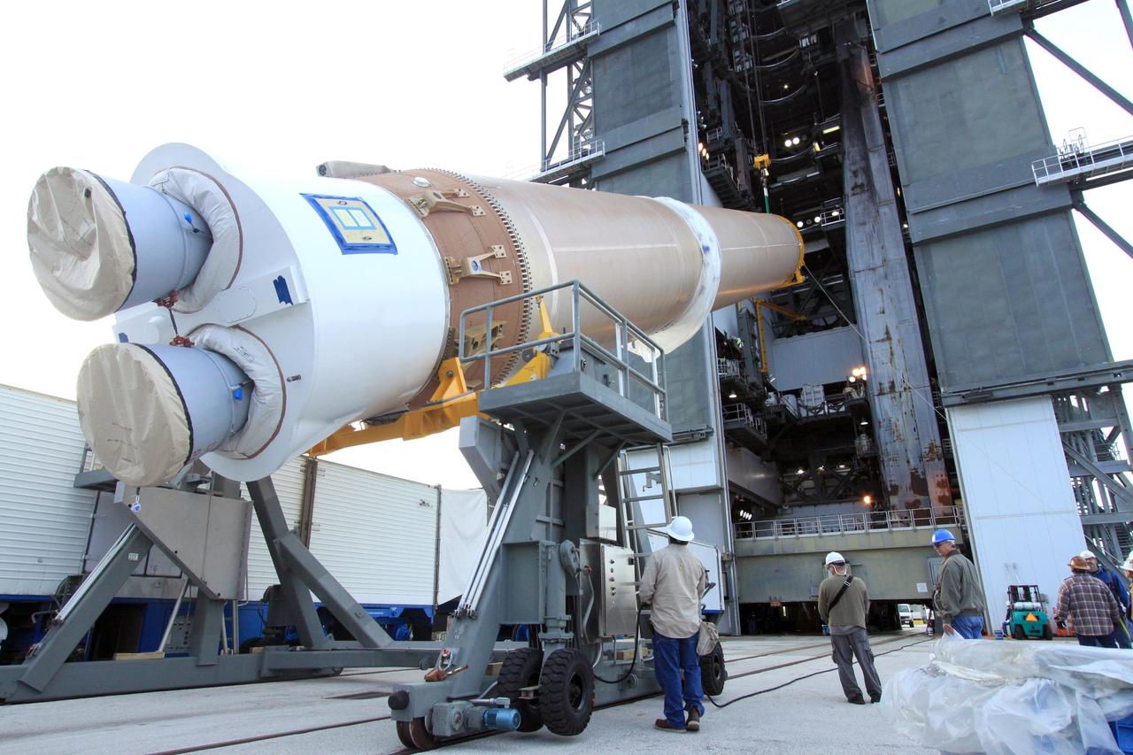 CAPE CANAVERAL, Fla. – Workers supervise the lift of the first stage of the United Launch Alliance Atlas V rocket for NASA's Magnetospheric Multiscale mission, or MMS, into the mobile service tower at Space Launch Complex 41 on Cape Canaveral Air Force Station in Florida. MMS will study the mystery of how magnetic fields around Earth connect and disconnect, explosively releasing energy via a process known a magnetic reconnection. MMS consists of four identical spacecraft that work together to provide the first three-dimensional view of this fundamental process, which occurs throughout the universe.  Launch is set for March 12. To learn more about MMS, visit http://www.nasa.gov/mms.  Photo credit: NASA/Jim Grossmann