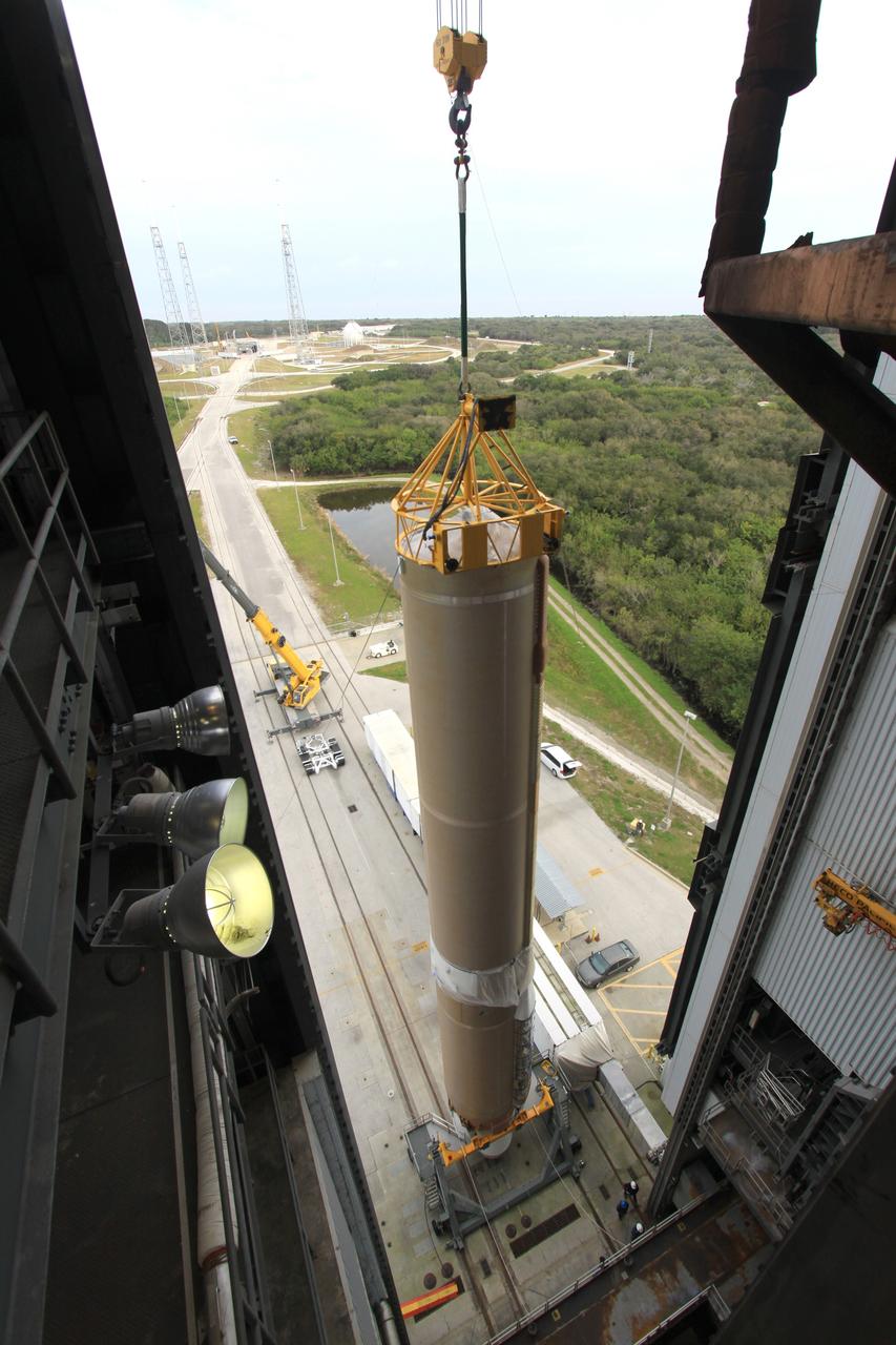 CAPE CANAVERAL, Fla. – A crane lifts the first stage of the United Launch Alliance Atlas V rocket for NASA's Magnetospheric Multiscale mission, or MMS, into the mobile service tower at Space Launch Complex 41 on Cape Canaveral Air Force Station in Florida. MMS will study the mystery of how magnetic fields around Earth connect and disconnect, explosively releasing energy via a process known a magnetic reconnection. MMS consists of four identical spacecraft that work together to provide the first three-dimensional view of this fundamental process, which occurs throughout the universe.  Launch is set for March 12. To learn more about MMS, visit http://www.nasa.gov/mms.  Photo credit: NASA/Jim Grossmann