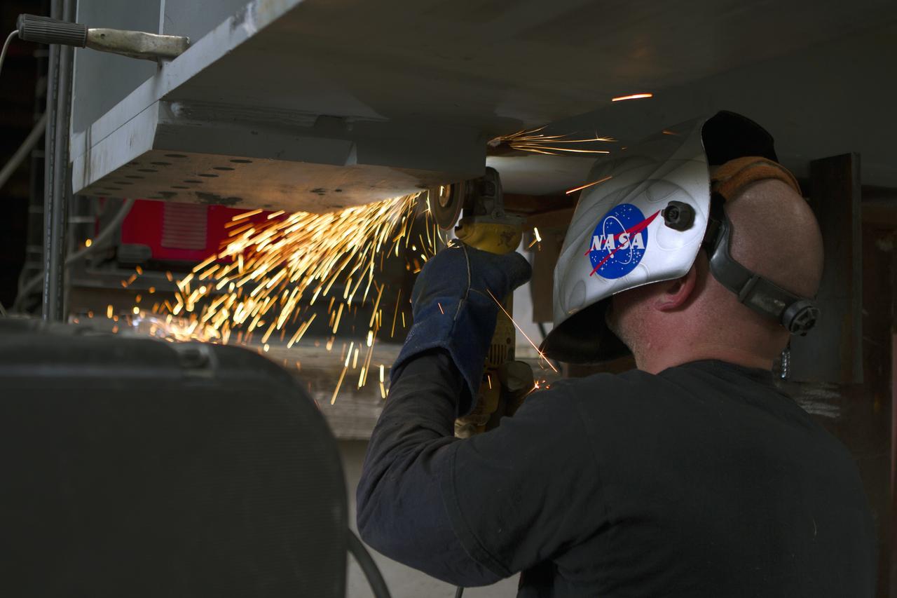A welder at Sauer Co. in Oak Hill, Florida, works on a segment of the first of 10 new work platforms that will be delivered for installation in high bay 3 of the Vehicle Assembly Building at NASA's Kennedy Space Center in Florida. A contract to modify high bay 3 was awarded by NASA to the Hensel Phelps Construction Co. of Orlando, Florida in March 2014. Sauer is a subcontractor to Hensel Phelps. The Ground Systems Development and Operations Program is overseeing upgrades and modifications to the high bay to support processing of NASA's Space Launch System and Orion spacecraft, and other exploration vehicles. Photo credit: NASA/Ben Smegelsky