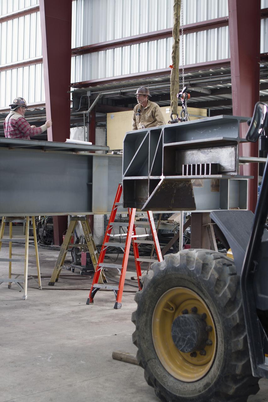 Construction workers at Sauer Co. in Oak Hill, Florida, work on the buildup of the first of 10 new work platforms that will be delivered for installation in high bay 3 of the Vehicle Assembly Building at NASA's Kennedy Space Center in Florida. A contract to modify high bay 3 was awarded by NASA to the Hensel Phelps Construction Co. of Orlando, Florida in March 2014. Sauer is a subcontractor to Hensel Phelps. The Ground Systems Development and Operations Program is overseeing upgrades and modifications to the high bay to support processing of NASA's Space Launch System and Orion spacecraft, and other exploration vehicles. Photo credit: NASA/Ben Smegelsky