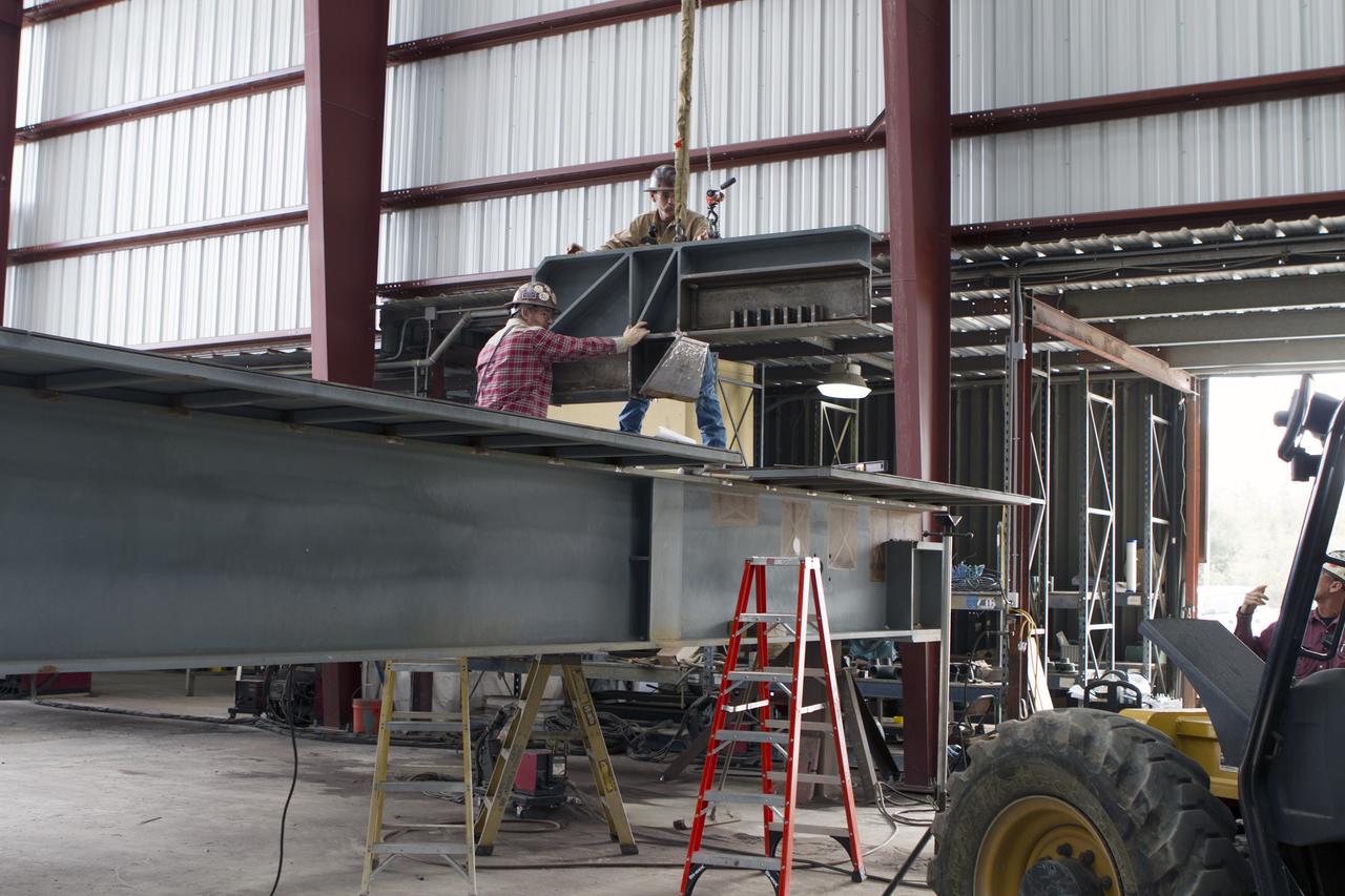 Construction workers at Sauer Co. in Oak Hill, Florida, work on the buildup of the first of 10 new work platforms that will be delivered for installation in high bay 3 of the Vehicle Assembly Building at NASA's Kennedy Space Center in Florida. A contract to modify high bay 3 was awarded by NASA to the Hensel Phelps Construction Co. of Orlando, Florida in March 2014. Sauer is a subcontractor to Hensel Phelps. The Ground Systems Development and Operations Program is overseeing upgrades and modifications to the high bay to support processing of NASA's Space Launch System and Orion spacecraft, and other exploration vehicles. Photo credit: NASA/Ben Smegelsky