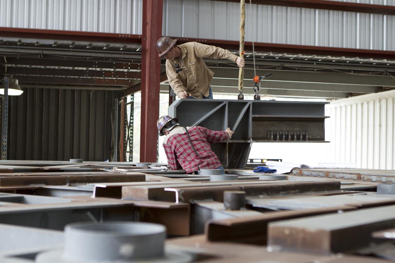 Construction workers at Sauer Co. in Oak Hill, Florida, work on the buildup of the first of 10 new work platforms that will be delivered for installation in high bay 3 of the Vehicle Assembly Building at NASA's Kennedy Space Center in Florida. A contract to modify high bay 3 was awarded by NASA to the Hensel Phelps Construction Co. of Orlando, Florida in March 2014. Sauer is a subcontractor to Hensel Phelps. The Ground Systems Development and Operations Program is overseeing upgrades and modifications to the high bay to support processing of NASA's Space Launch System and Orion spacecraft, and other exploration vehicles. Photo credit: NASA/Ben Smegelsky