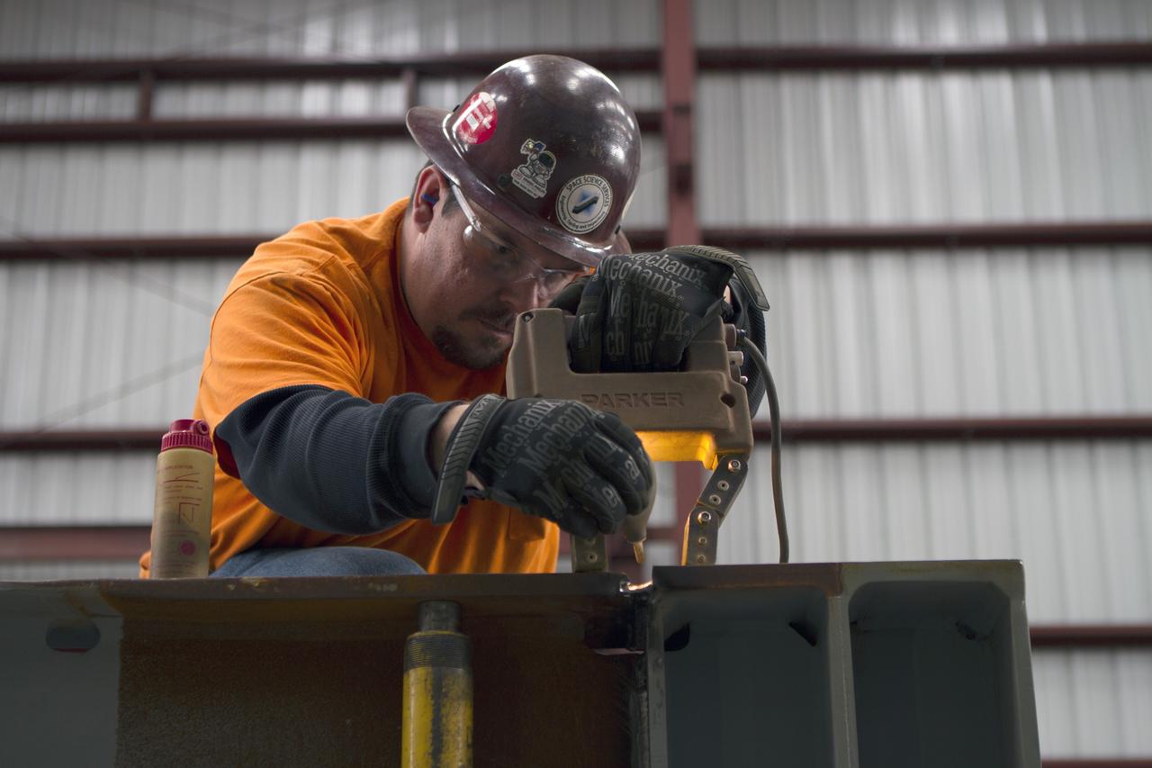 A construction worker at Sauer Co. in Oak Hill, Florida, works on the buildup of the first of 10 new work platforms that will be delivered for installation in high bay 3 of the Vehicle Assembly Building at NASA's Kennedy Space Center in Florida. A contract to modify high bay 3 was awarded by NASA to the Hensel Phelps Construction Co. of Orlando, Florida in March 2014. Sauer is a subcontractor to Hensel Phelps. The Ground Systems Development and Operations Program is overseeing upgrades and modifications to the high bay to support processing of NASA's Space Launch System and Orion spacecraft, and other exploration vehicles. Photo credit: NASA/Ben Smegelsky