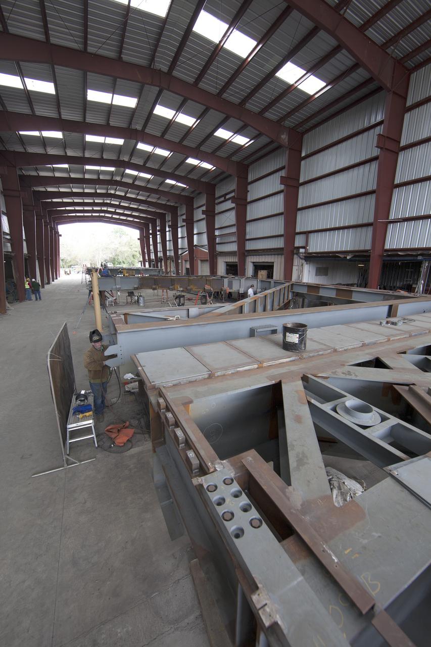 Construction workers at Sauer in Oak Hill, Florida, work on the buildup of the first of 10 new work platforms that will be delivered for installation in high bay 3 of the Vehicle Assembly Building at NASA's Kennedy Space Center in Florida. A contract to modify high bay 3 was awarded by NASA to the Hensel Phelps Construction Co. of Orlando, Florida in March 2014. Sauer is a subcontractor to Hensel Phelps. The Ground Systems Development and Operations Program is overseeing upgrades and modifications to the high bay to support processing of NASA's Space Launch System and Orion spacecraft, and other exploration vehicles. Photo credit: NASA/Ben Smegelsky
