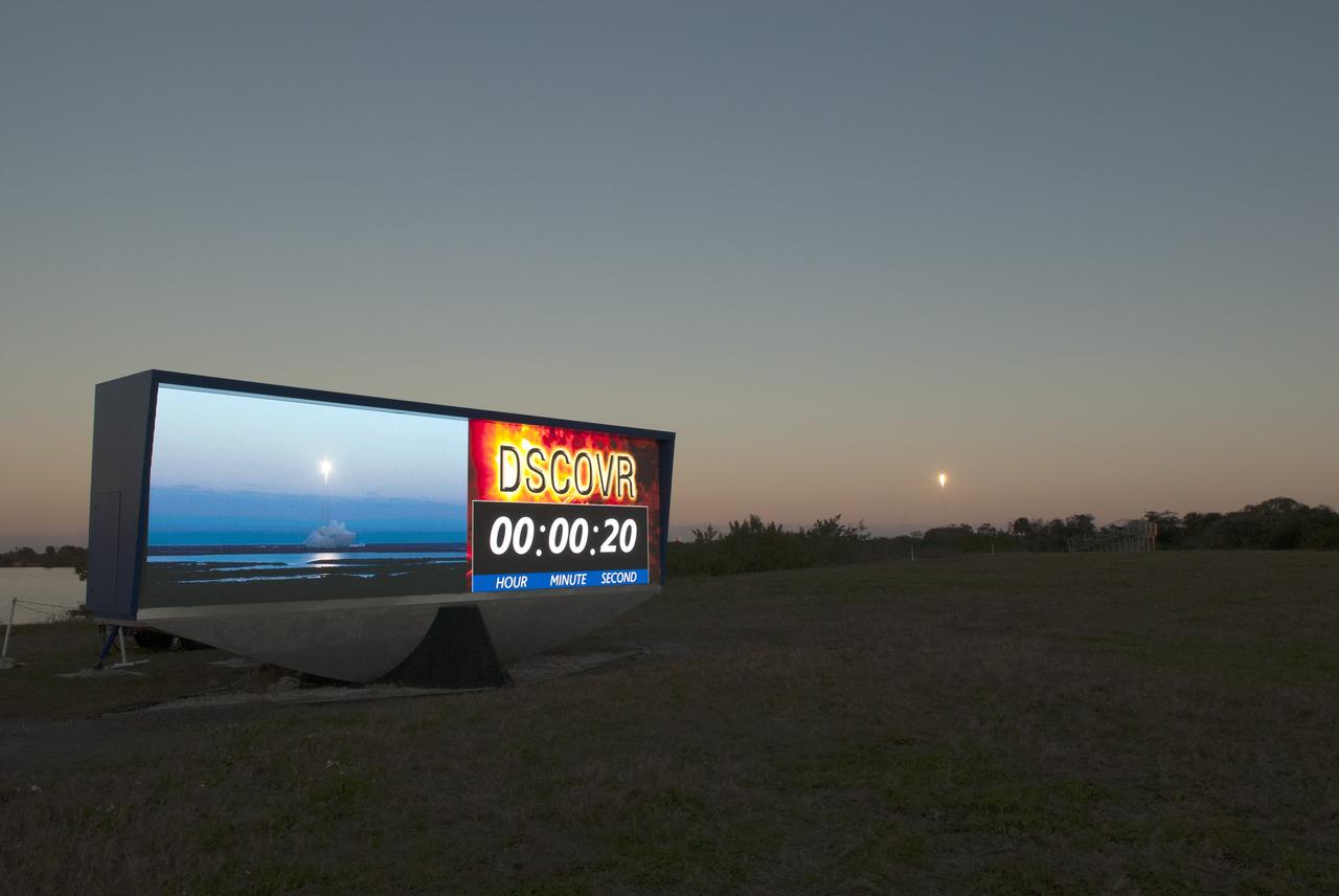 The SpaceX Falcon 9 rocket carrying NOAA’s Deep Space Climate Observatory spacecraft, or DSCOVR, rises above the treeline as a realtime camera view of the launch is visible on the countdown clock at NASA’s Kennedy Space Center in Florida. The Falcon 9 launched from Space Launch Complex 40 at Cape Canaveral Air Force Station at 6:03 p.m. EST. DSCOVR is a partnership between NOAA, NASA and the U.S. Air Force, and will maintain the nation's real-time solar wind monitoring capabilities. To learn more about DSCOVR, visit http://www.nesdis.noaa.gov/DSCOVR. Photo credit: NASA/Frankie Martin
