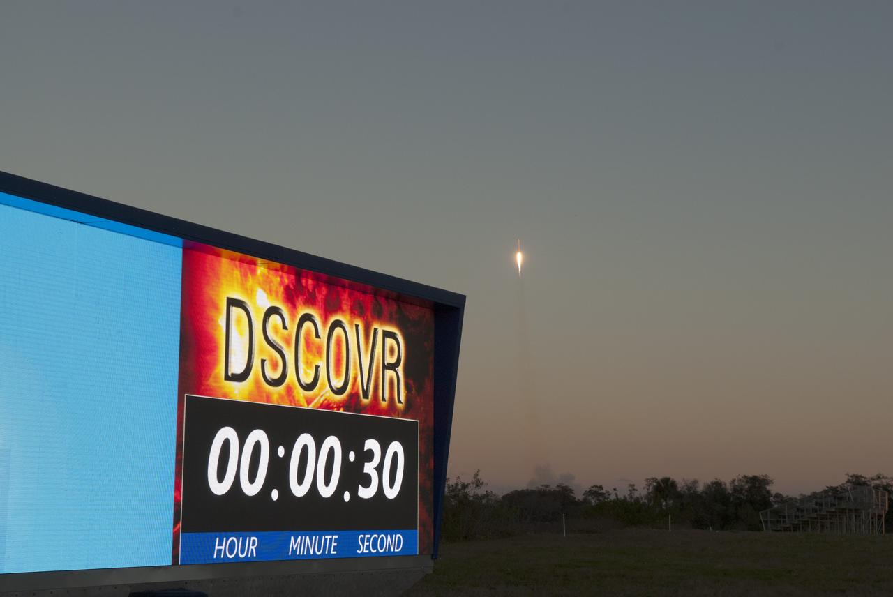 The countdown clock at NASA’s Kennedy Space Center in Florida reads 30 seconds into flight of the SpaceX Falcon 9 rocket carrying NOAA’s Deep Space Climate Observatory spacecraft, or DSCOVR, seen rising in the background. The Falcon 9 launched from Space Launch Complex 40 at Cape Canaveral Air Force Station at 6:03 p.m. EST. DSCOVR is a partnership between NOAA, NASA and the U.S. Air Force, and will maintain the nation's real-time solar wind monitoring capabilities. To learn more about DSCOVR, visit http://www.nesdis.noaa.gov/DSCOVR. Photo credit: NASA/Frankie Martin