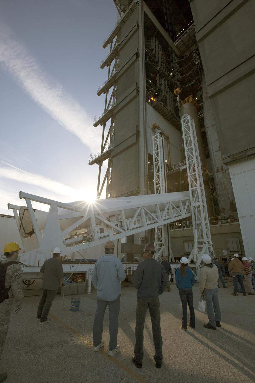 A solid rocket motor for the United Launch Alliance Atlas V rocket slated to boost NASA's Magnetospheric Multiscale mission, or MMS, is lifted at the mobile service tower at Space Launch Complex 41 on Cape Canaveral Air Force Station in Florida. Four identical MMS spacecraft will study the mystery of how magnetic fields around Earth connect and disconnect, explosively releasing energy via a process known a magnetic reconnection. Launch is set for March 12. To learn more: http://www.nasa.gov/mms. Photo credit: NASA/ Kim Shiflett