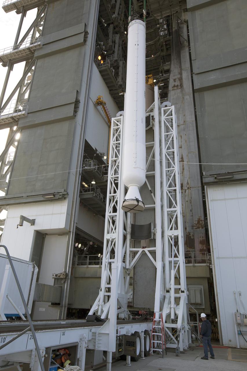 A solid rocket motor for the United Launch Alliance Atlas V rocket slated to boost NASA's Magnetospheric Multiscale mission, or MMS, is lifted at the mobile service tower at Space Launch Complex 41 on Cape Canaveral Air Force Station in Florida. Four identical MMS spacecraft will study the mystery of how magnetic fields around Earth connect and disconnect, explosively releasing energy via a process known a magnetic reconnection. Launch is set for March 12. To learn more: http://www.nasa.gov/mms. Photo credit: NASA/ Kim Shiflett