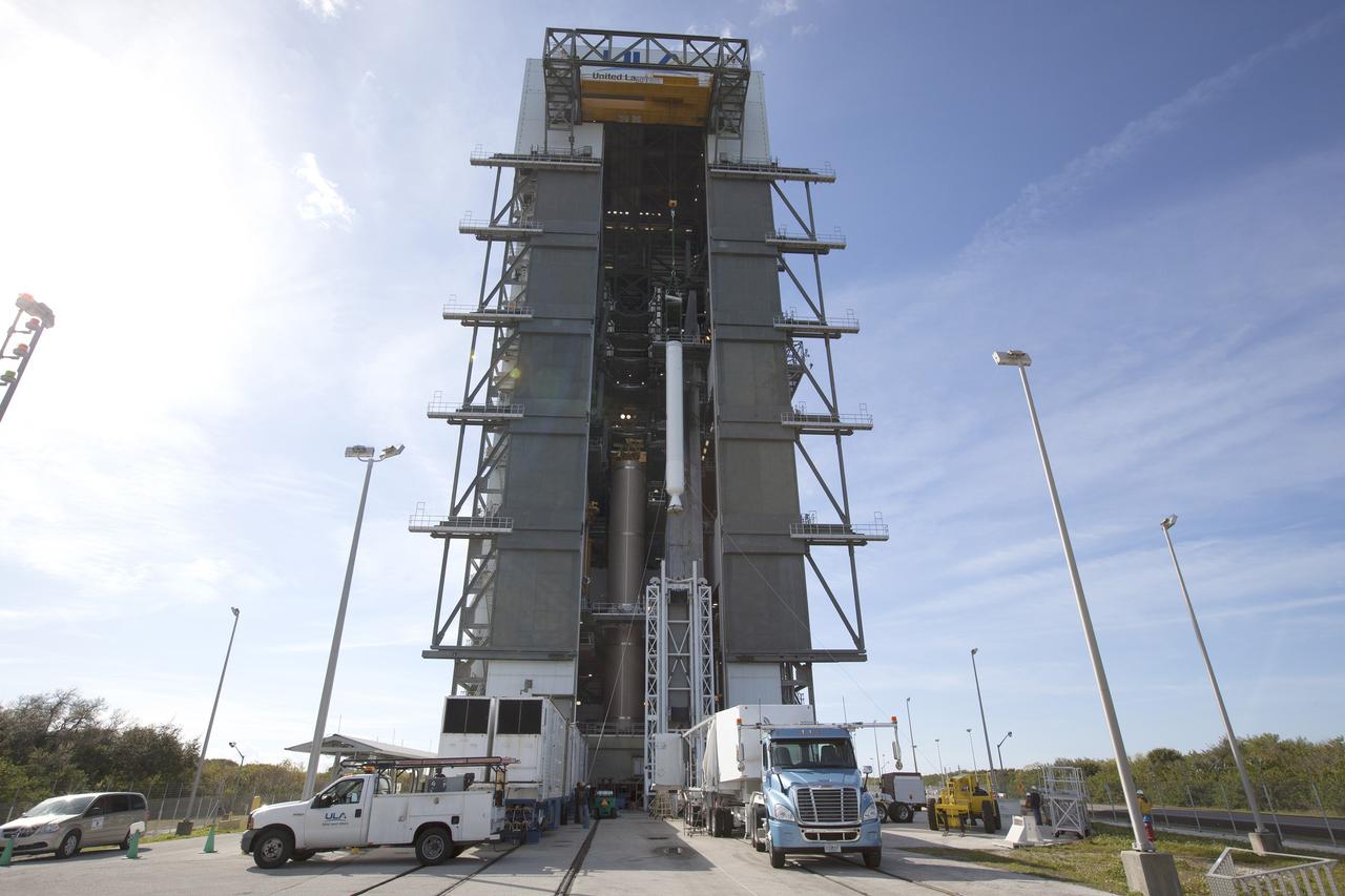 A solid rocket motor for the United Launch Alliance Atlas V rocket slated to boost NASA's Magnetospheric Multiscale mission, or MMS, is lifted at the mobile service tower at Space Launch Complex 41 on Cape Canaveral Air Force Station in Florida. Four identical MMS spacecraft will study the mystery of how magnetic fields around Earth connect and disconnect, explosively releasing energy via a process known a magnetic reconnection. Launch is set for March 12. To learn more: http://www.nasa.gov/mms. Photo credit: NASA/ Kim Shiflett