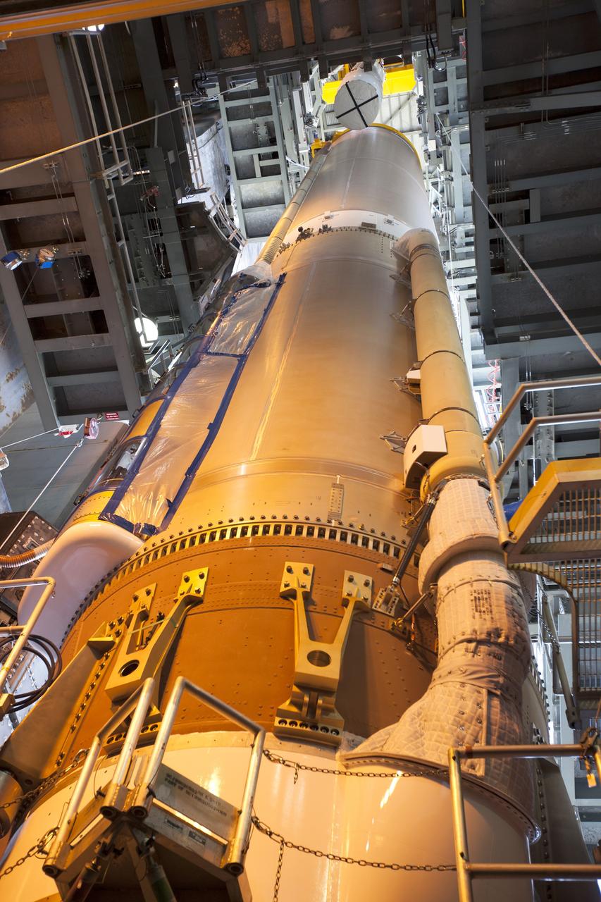 A solid rocket motor for the United Launch Alliance Atlas V rocket slated to boost NASA's Magnetospheric Multiscale mission, or MMS, is lowered into position inside the mobile service tower at Space Launch Complex 41 on Cape Canaveral Air Force Station in Florida. Four identical MMS spacecraft will study the mystery of how magnetic fields around Earth connect and disconnect, explosively releasing energy via a process known a magnetic reconnection. Launch is set for March 12. To learn more: http://www.nasa.gov/mms. Photo credit: NASA/ Kim Shiflett