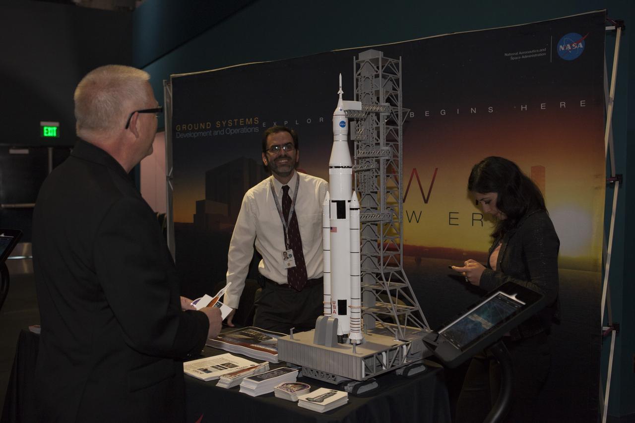 In the Space Shuttle Atlantis exhibit facility at the Kennedy Space Center's Visitor Complex, a guest is briefed on work taking place in the Florida spaceport's Ground Systems Development and Operations Program. This followed a presentation by center director Bob Cabana who updated community leaders on current and future activities at the space center.