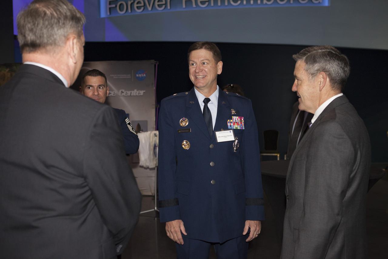 In the Space Shuttle Atlantis exhibit facility at the Kennedy Space Center's Visitor Complex, center director Bob Cabana, right, speaks with Brig. Gen. Wayne Monteith, center, commander of the U.S. Air Force 45th Space Wing, and director of Eastern Range at Patrick Air Force Base, Florida. This followed a presentation by Cabana who updated community leaders on current and future activities at the space center.