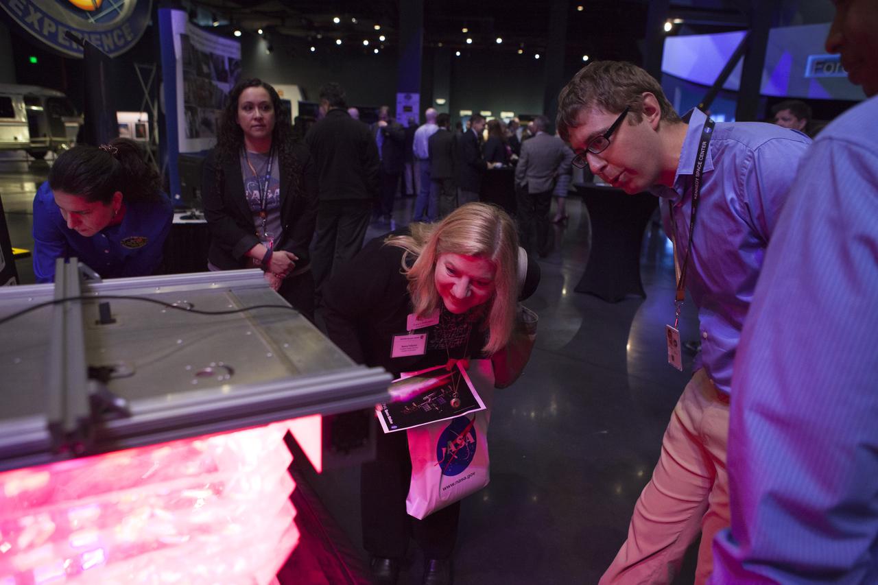 In the Space Shuttle Atlantis exhibit facility at the Kennedy Space Center's Visitor Complex, guests get a close-up look at a plant growth experiment similar to one aboard the International Space Station. This followed a presentation by center director Bob Cabana who updated community leaders on current and future activities at the space center.