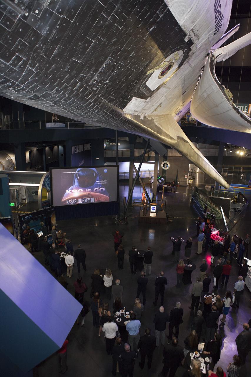 In the Space Shuttle Atlantis exhibit facility at the Kennedy Space Center's Visitor Complex, center director Bob Cabana, in the center background, speaks to guests as he updates community leaders on current and future activities at the space center.