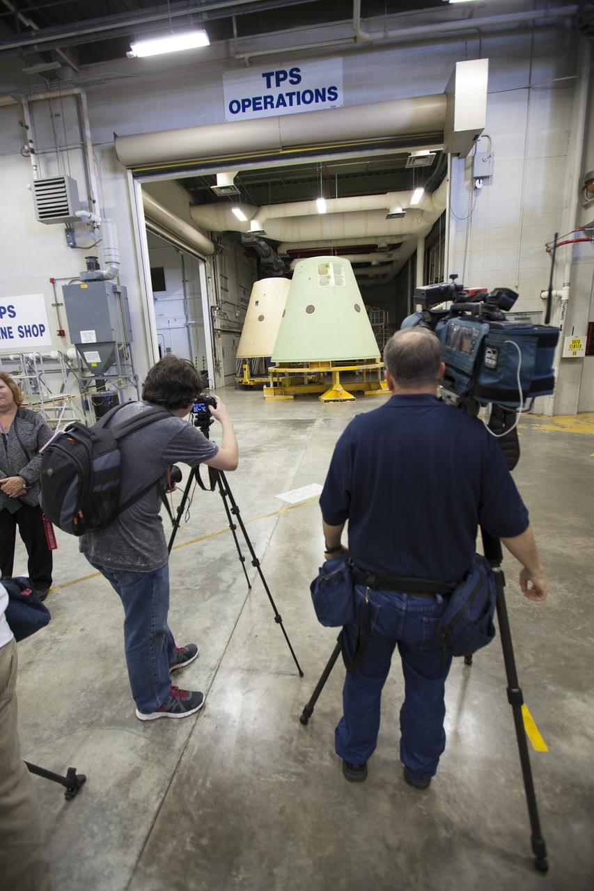 Inside the Booster Fabrication Facility (BFF) at NASA’s Kennedy Space Center in Florida, members of the news media photograph a frustrum that will be stacked atop a forward skirt for one of NASA’s Space Launch System (SLS) solid rocket boosters. Orbital ATK is a contractor for NASA’s Marshall Space Flight Center in Alabama, and operates the BFF to prepare aft booster segments and hardware for the SLS solid rocket boosters. The SLS rocket and Orion spacecraft will launch on Exploration Mission-1 in 2018. The Ground Systems Development and Operations Program is preparing the infrastructure to process and launch spacecraft on deep-space missions and the journey to Mars. 