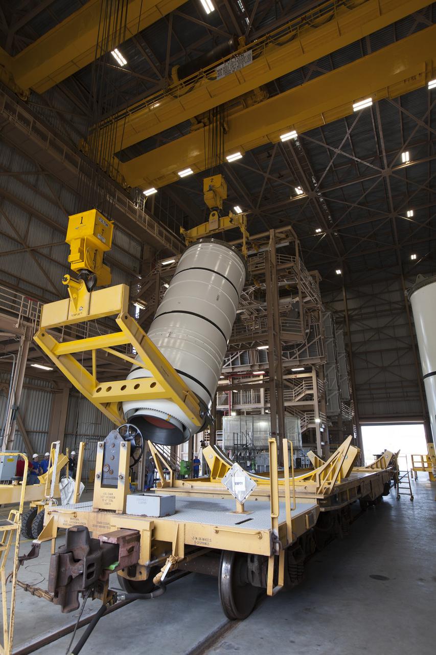 During a media tour of the Rotation, Processing and Surge Facility (RPSF) at NASA’s Kennedy Space Center in Florida, two cranes are used to lift one of two pathfinders, or test versions, of solid rocket booster segments for NASA’s Space Launch System rocket into the vertical position. The pathfinder booster segment will be moved to the other end of the RPSF and secured on a test stand. The Ground Systems Development and Operations Program and Jacobs Engineering, on the Test and Operations Support Contract, will prepare the booster segments, which are inert, for a series of lifts, moves and stacking operations to prepare for Exploration Mission-1, deep-space missions and the journey to Mars. 