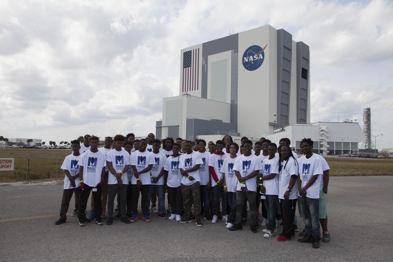 Students in the My Brother’s Keeper program pose for a group photo in front of NASA Kennedy Space Center’s iconic Vehicle Assembly Building and Launch Control Center.  The Florida spaceport is one of six NASA centers that participated in My Brother’s Keeper National Lab Week. The event is a nationwide effort to bring youth from underrepresented communities into federal labs and centers for hands-on activities, tours and inspirational speakers. Sixty students from the nearby cities of Orlando and Sanford visited Kennedy, where they toured the Vehicle Assembly Building, the Space Station Processing Facility and the center’s innovative Swamp Works Labs. The students also had a chance to meet and ask questions of a panel of subject matter experts from across Kennedy.